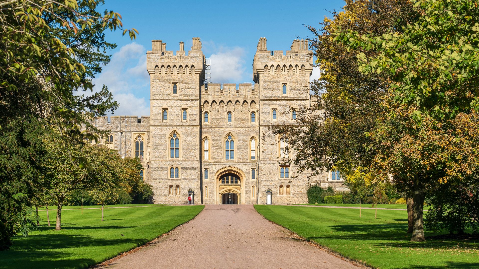 a large castle with a long driveway leading to it