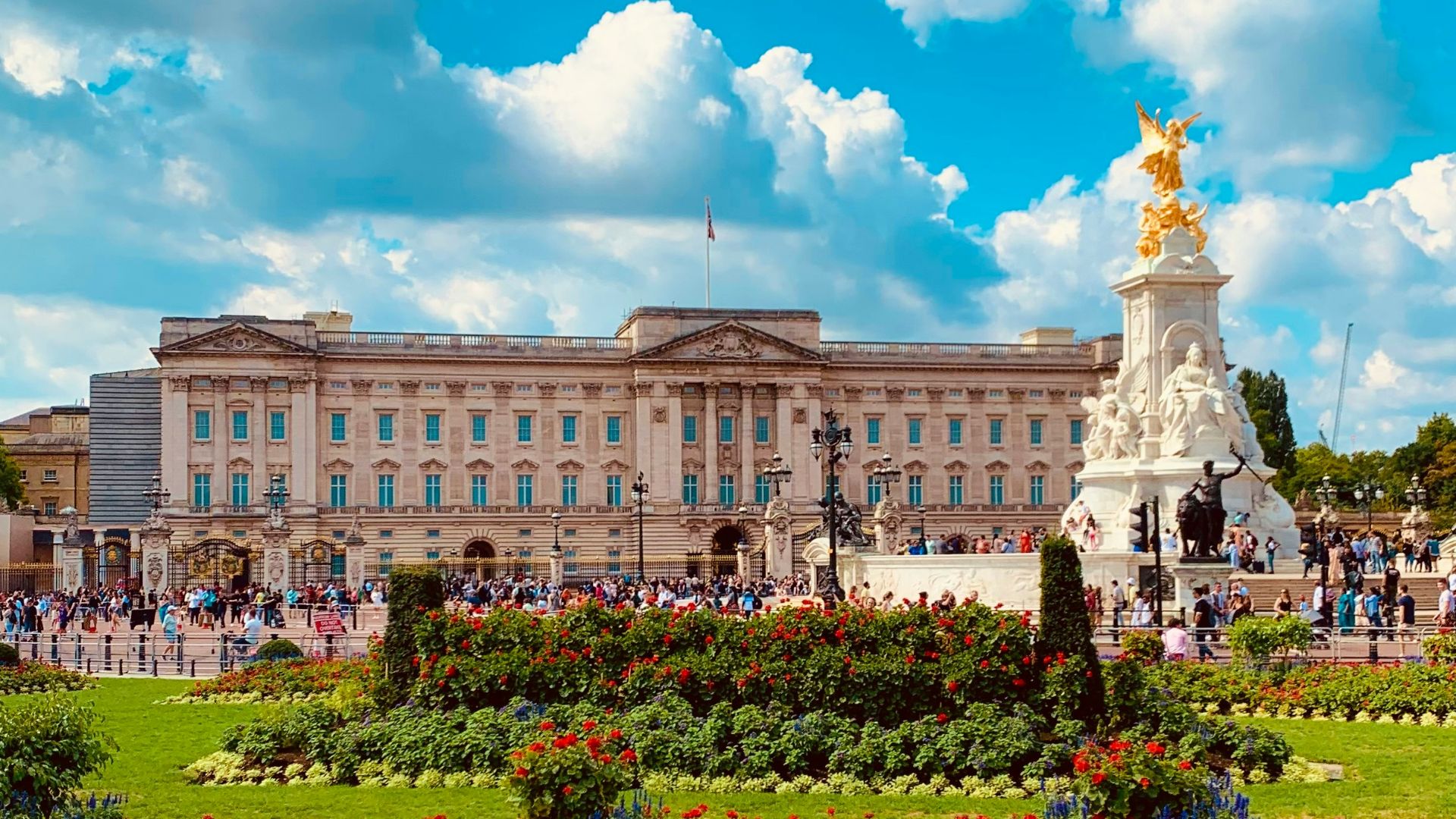 a large building with a statue in the middle of a garden