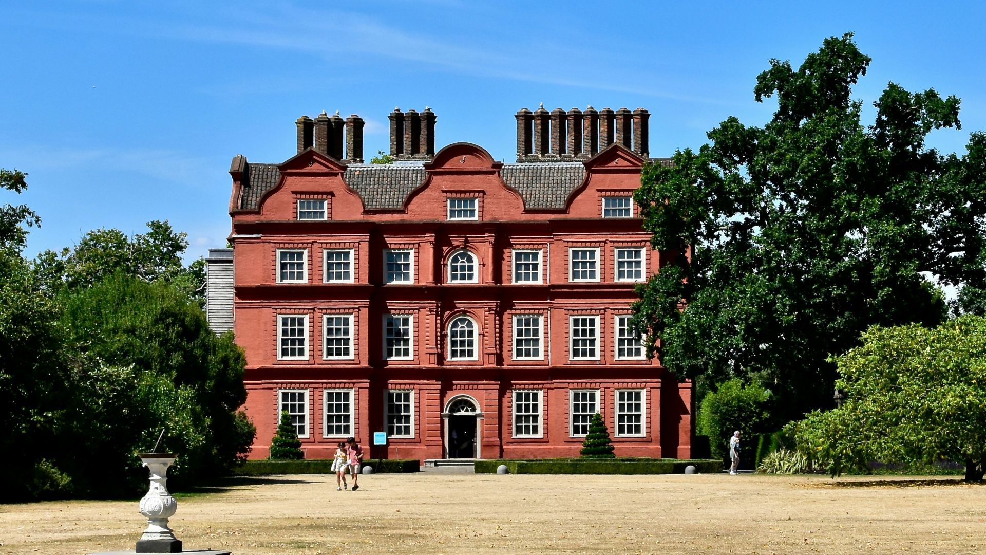 a large red building with trees in front of it