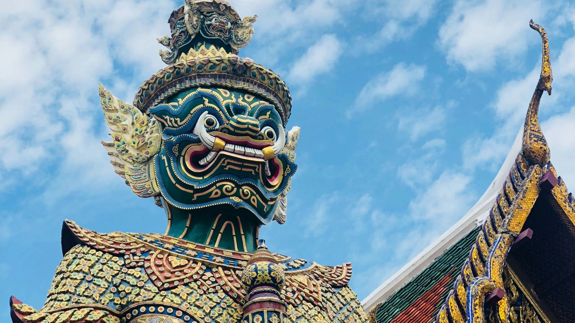 gold and blue dragon statue under blue sky during daytime