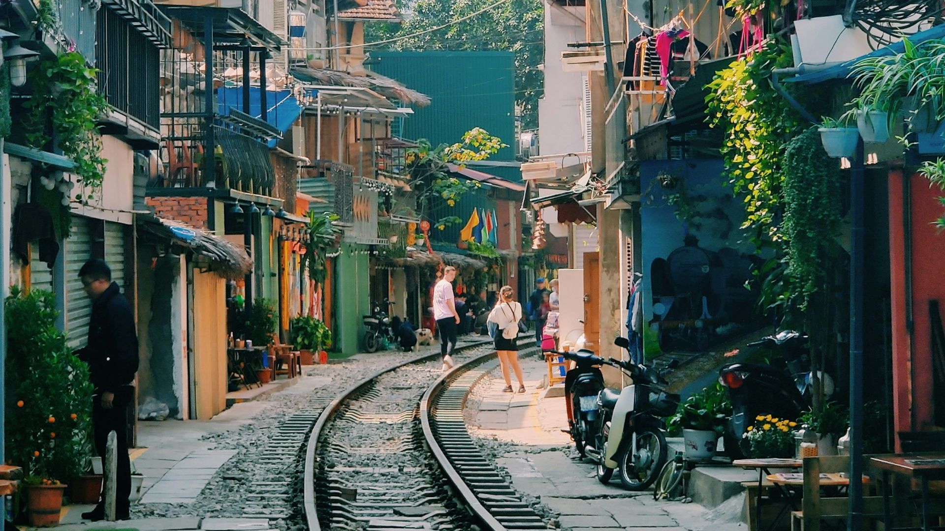 people walking on sidewalk near buildings during daytime