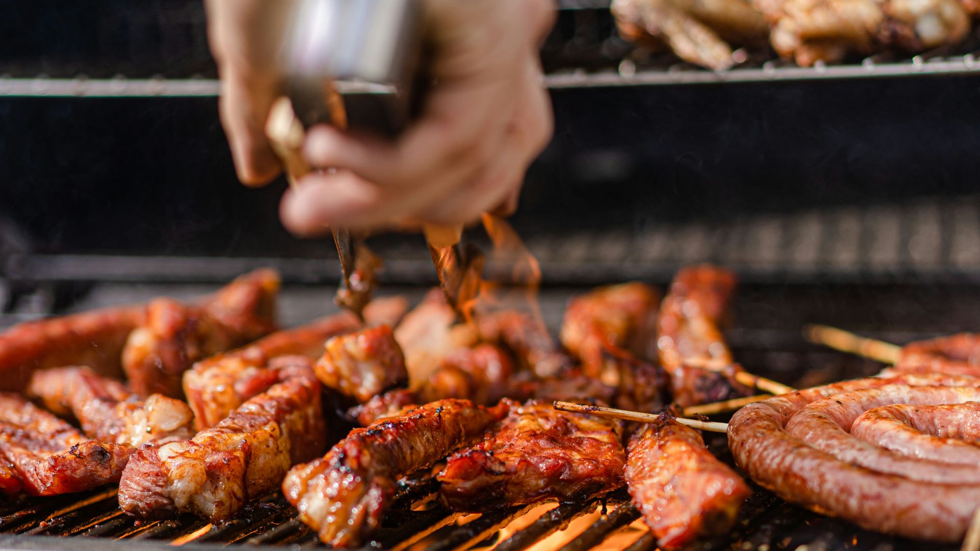 a person is cooking meat on a grill