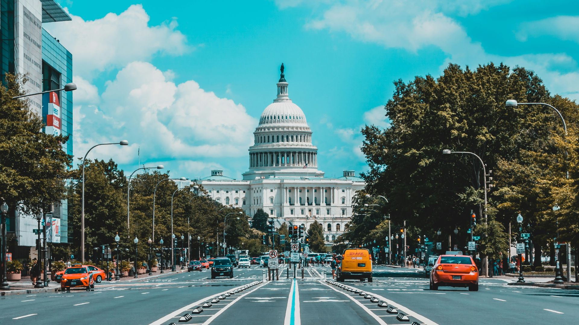 wide road with vehicle traveling with white dome building