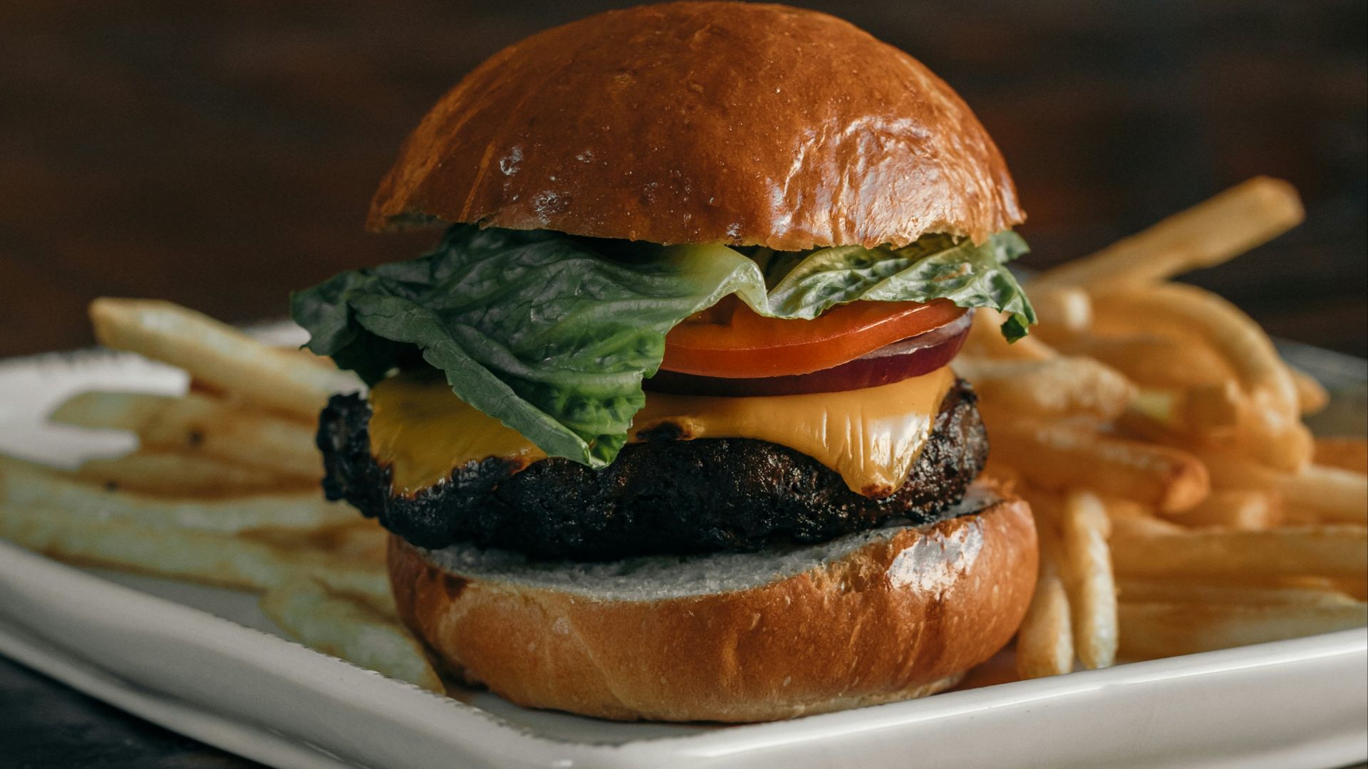 a cheeseburger and fries on a plate on a table
