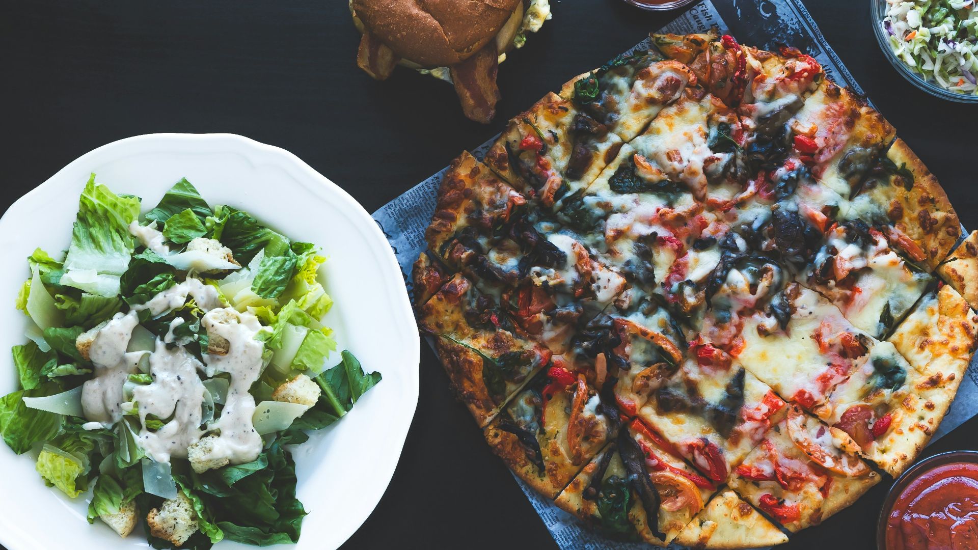 pizza with green vegetable on white ceramic plate