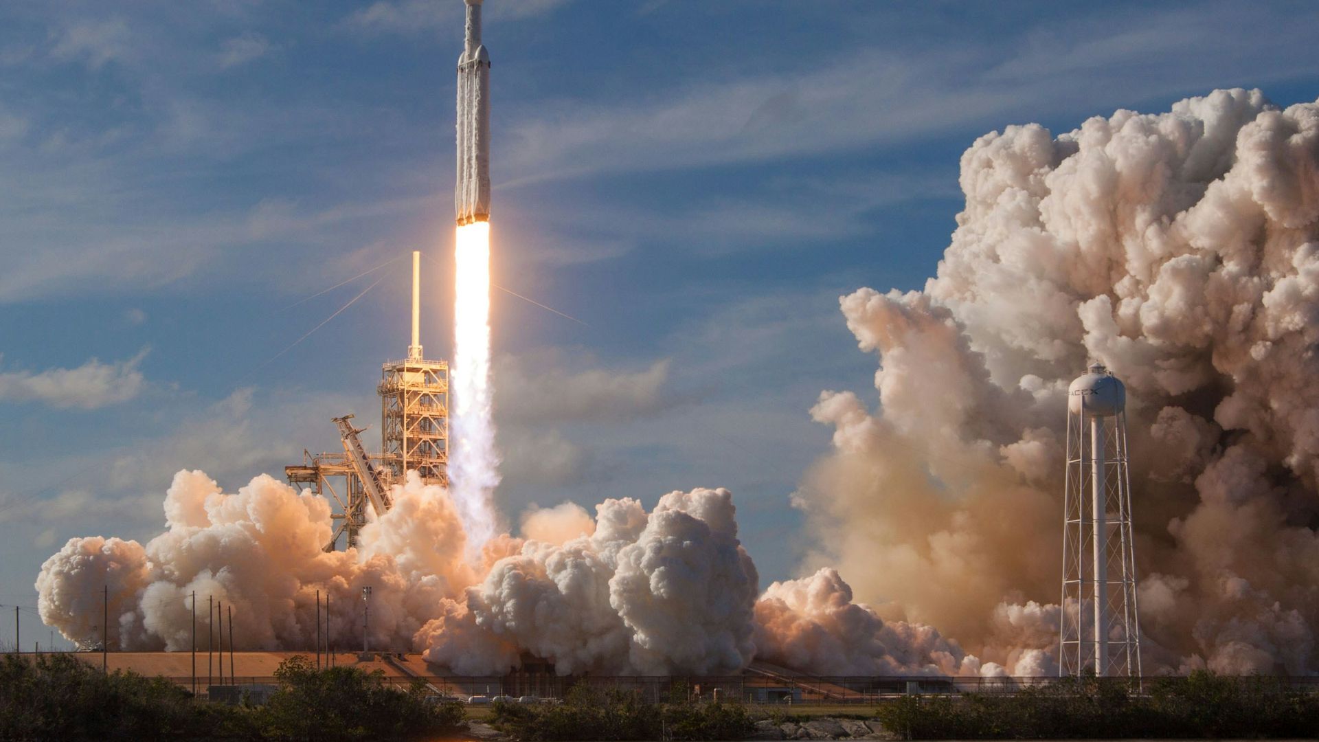 gray spacecraft taking off during daytime