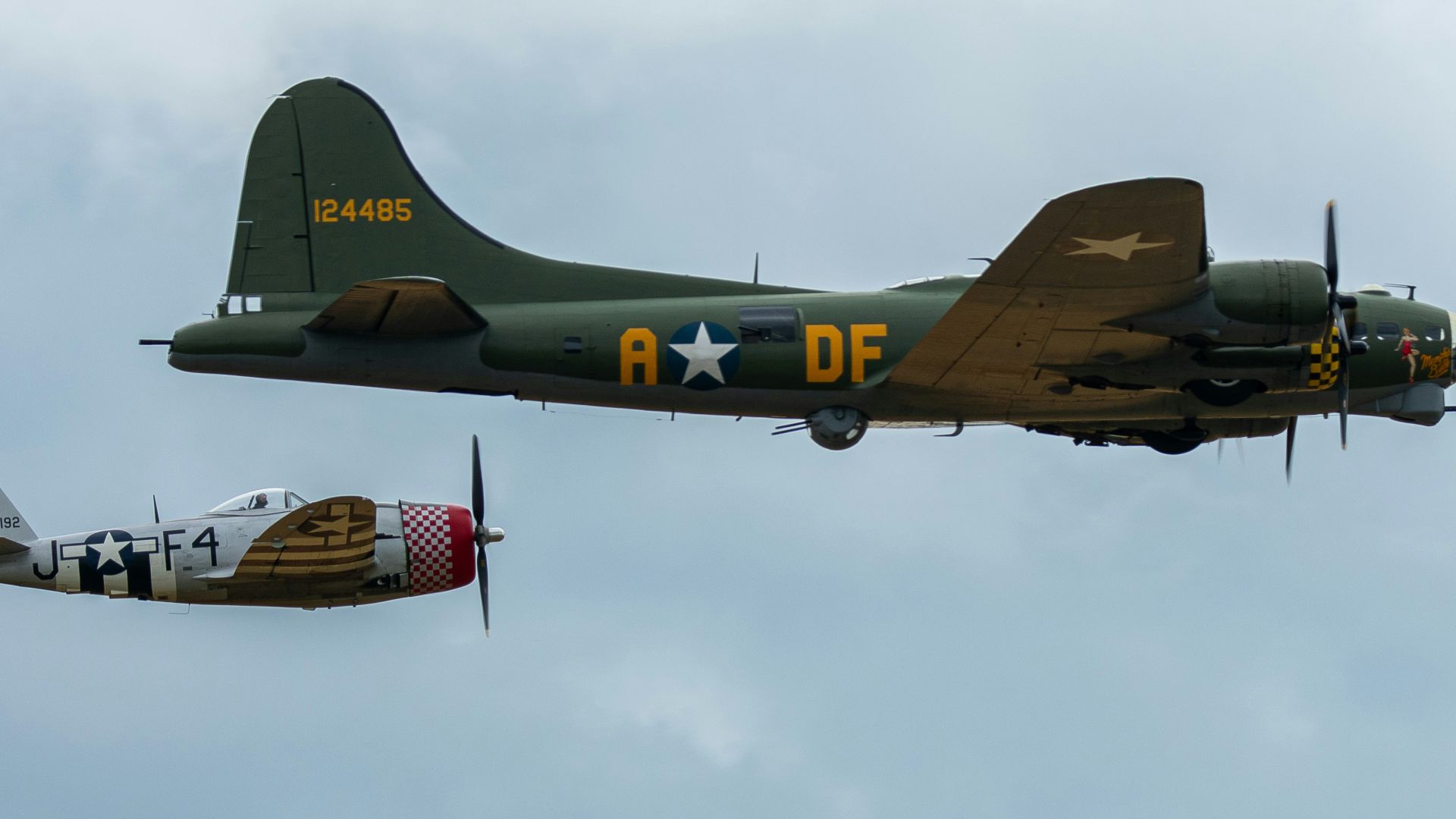 two airplanes flying side by side in the sky