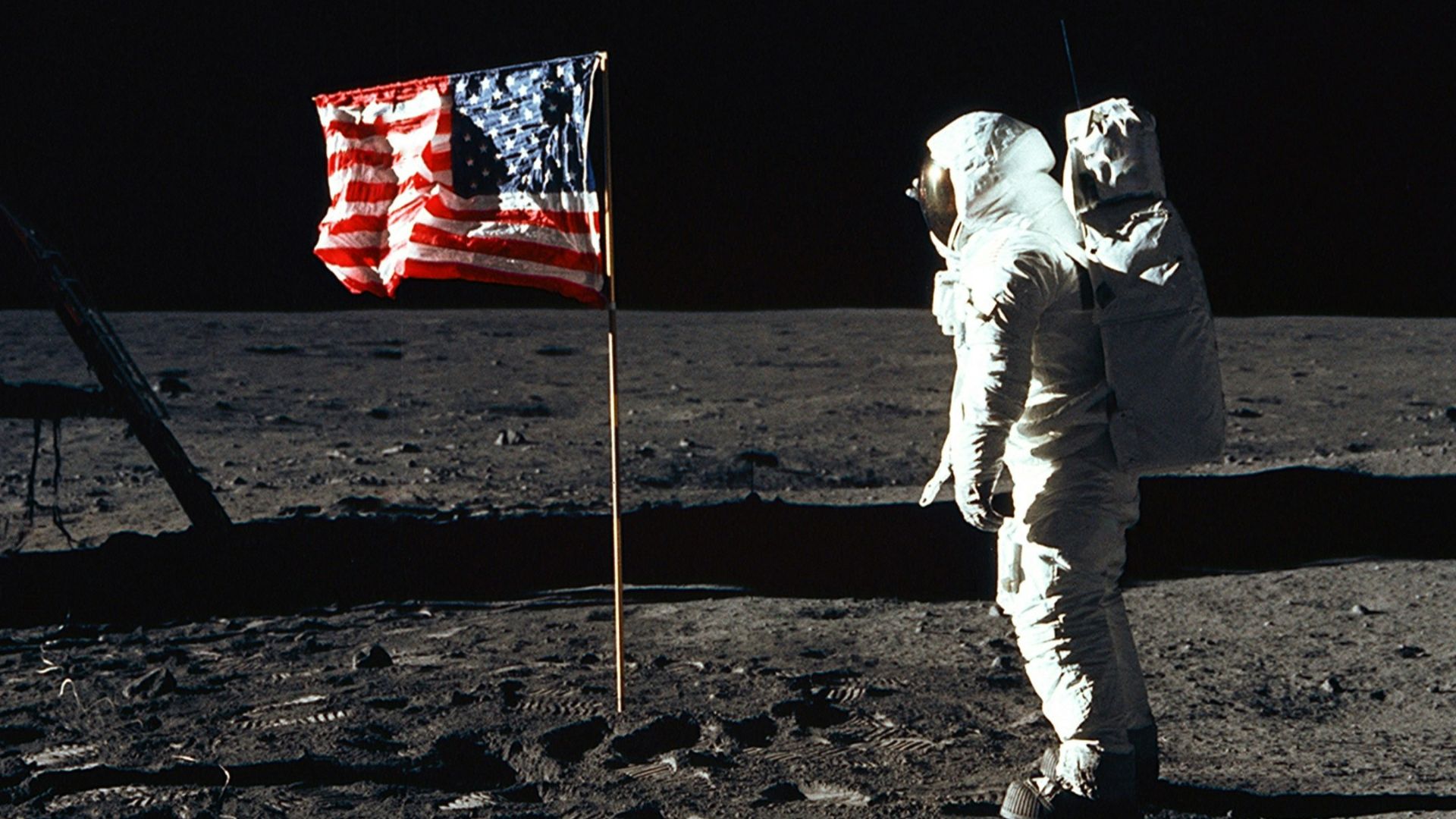 Buzz Aldrin on the moon in front of the US flag