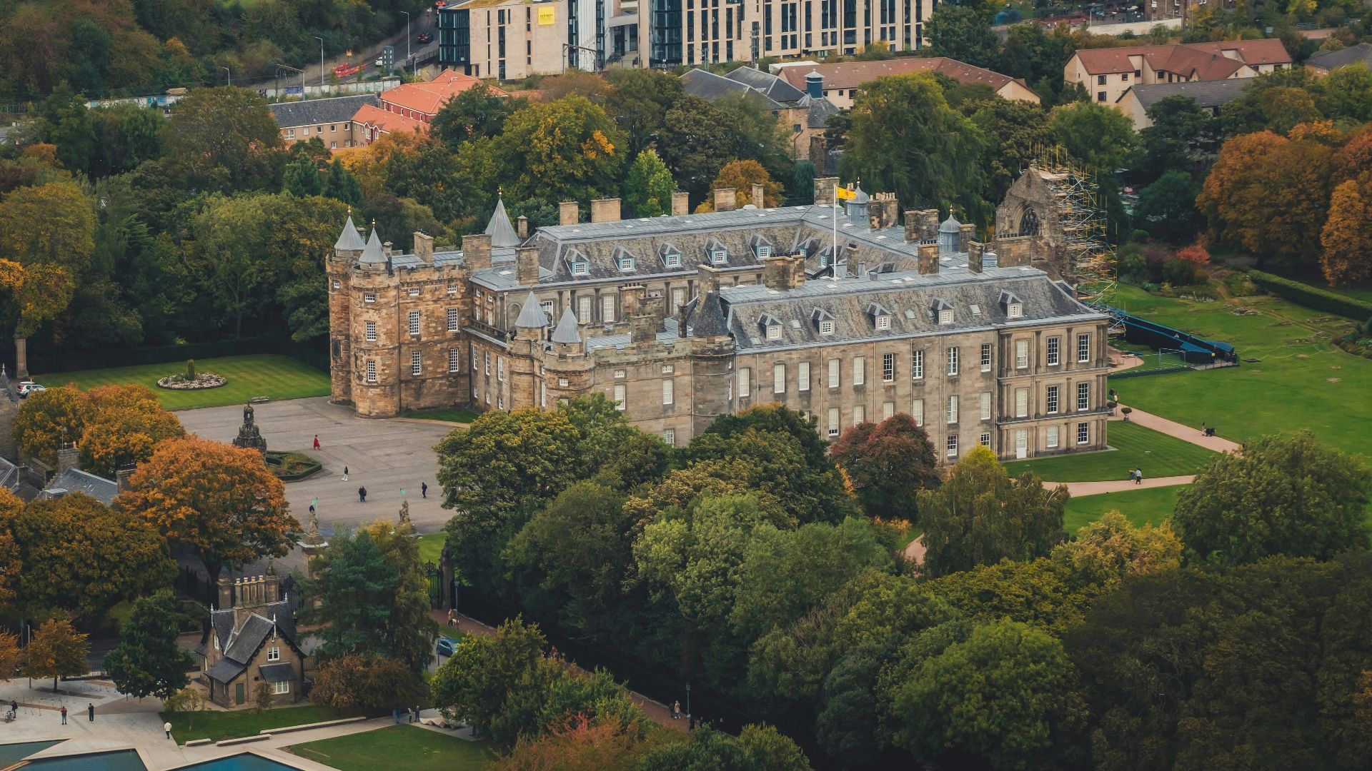 an aerial view of a large building surrounded by trees