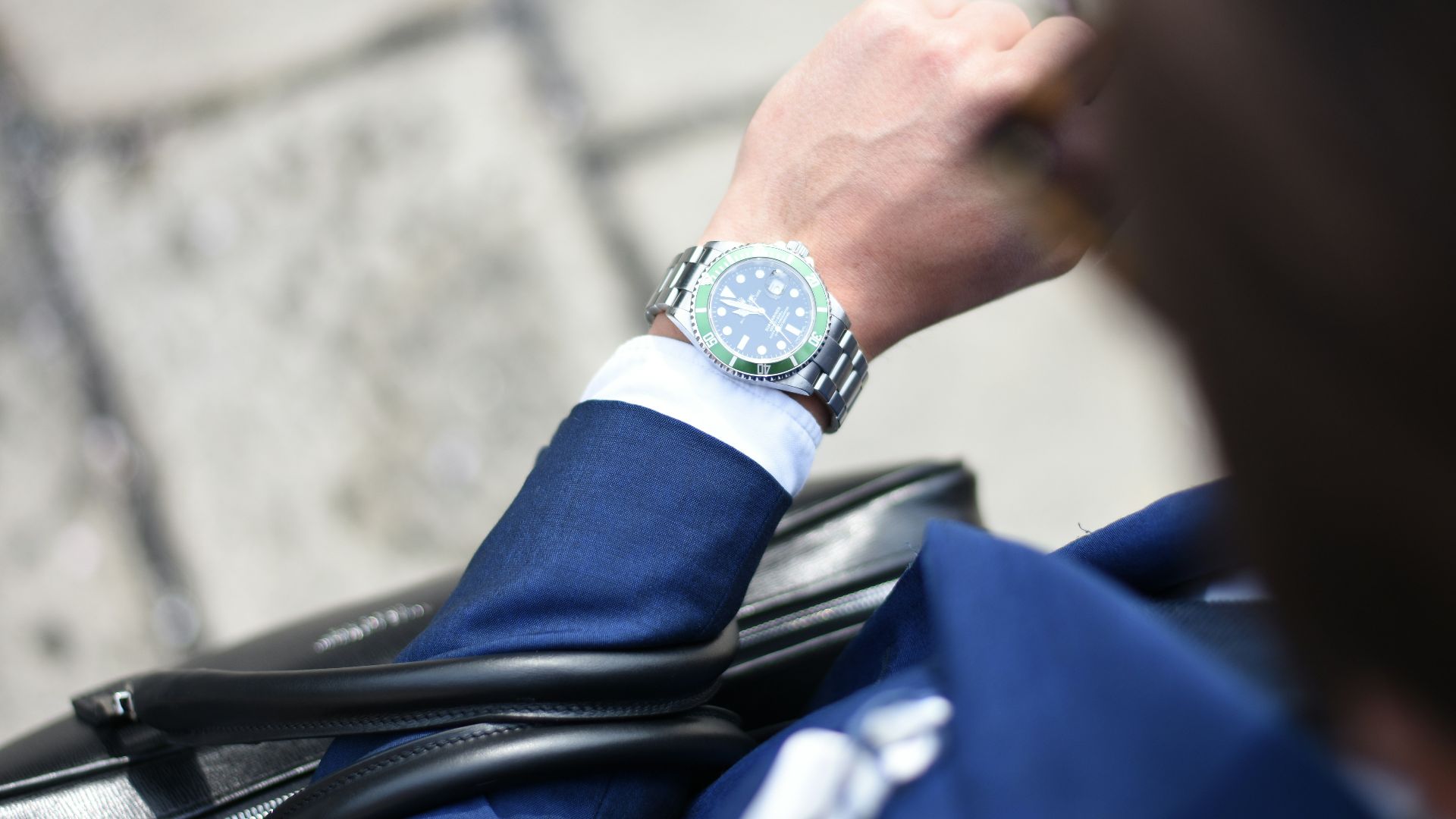 person looking at silver-colored analog watch