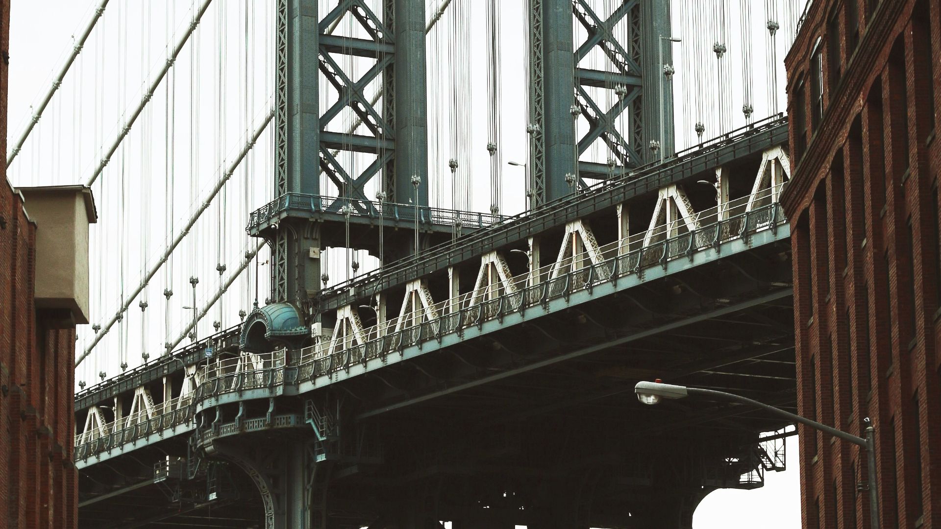 vehicles parked along the road near metal bridge