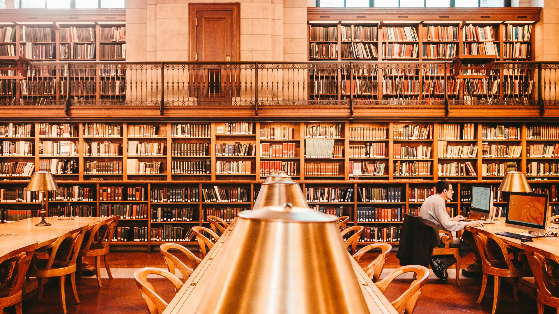 man sitting on chair inside library