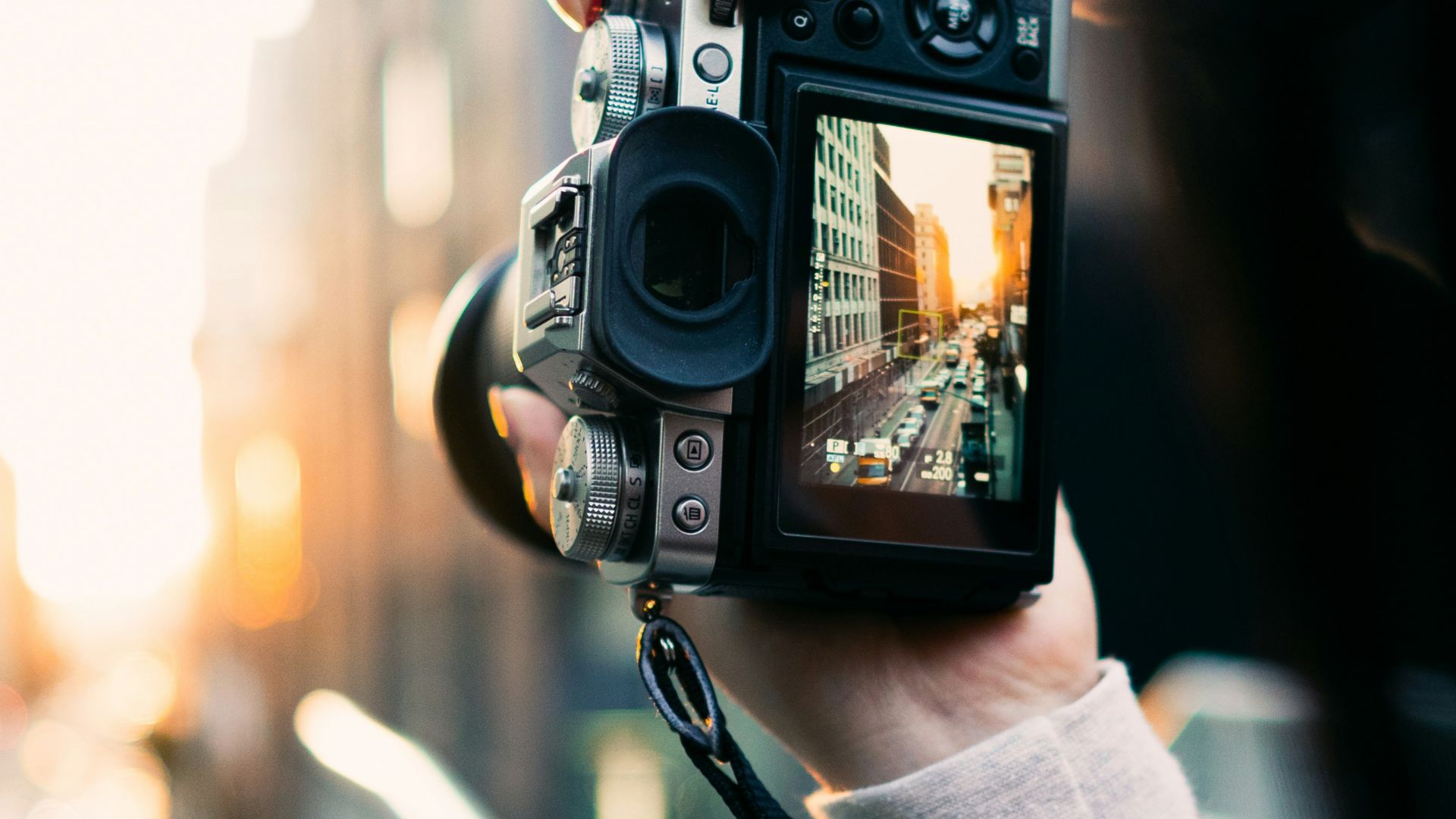 person holding black and silver camera