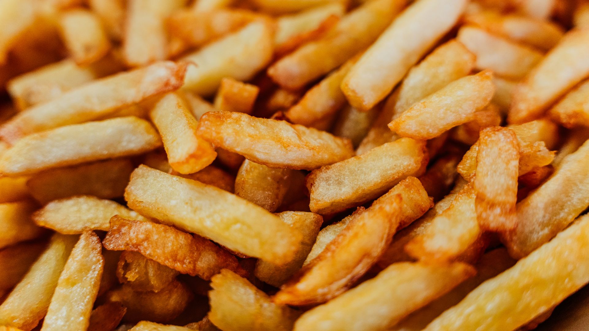 a pile of french fries sitting on top of a table