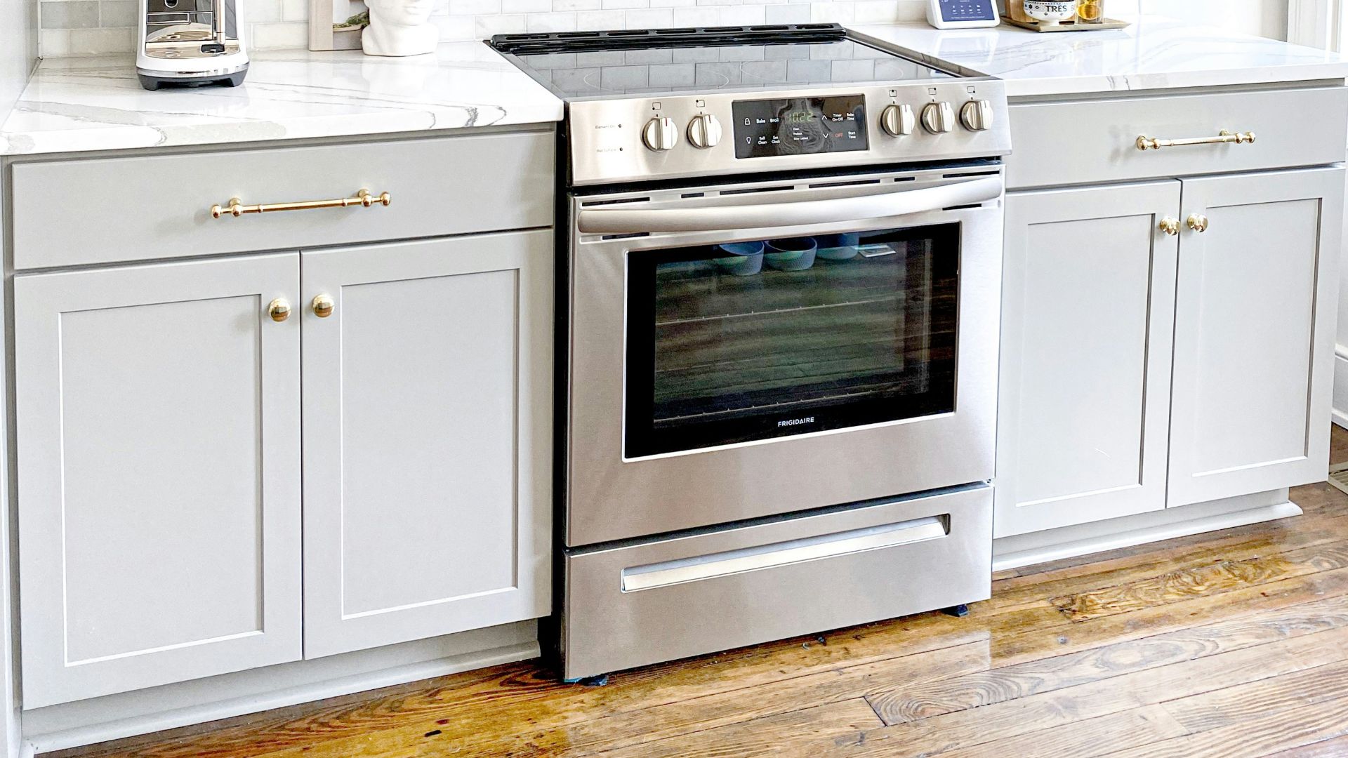 white microwave oven on white wooden cabinet