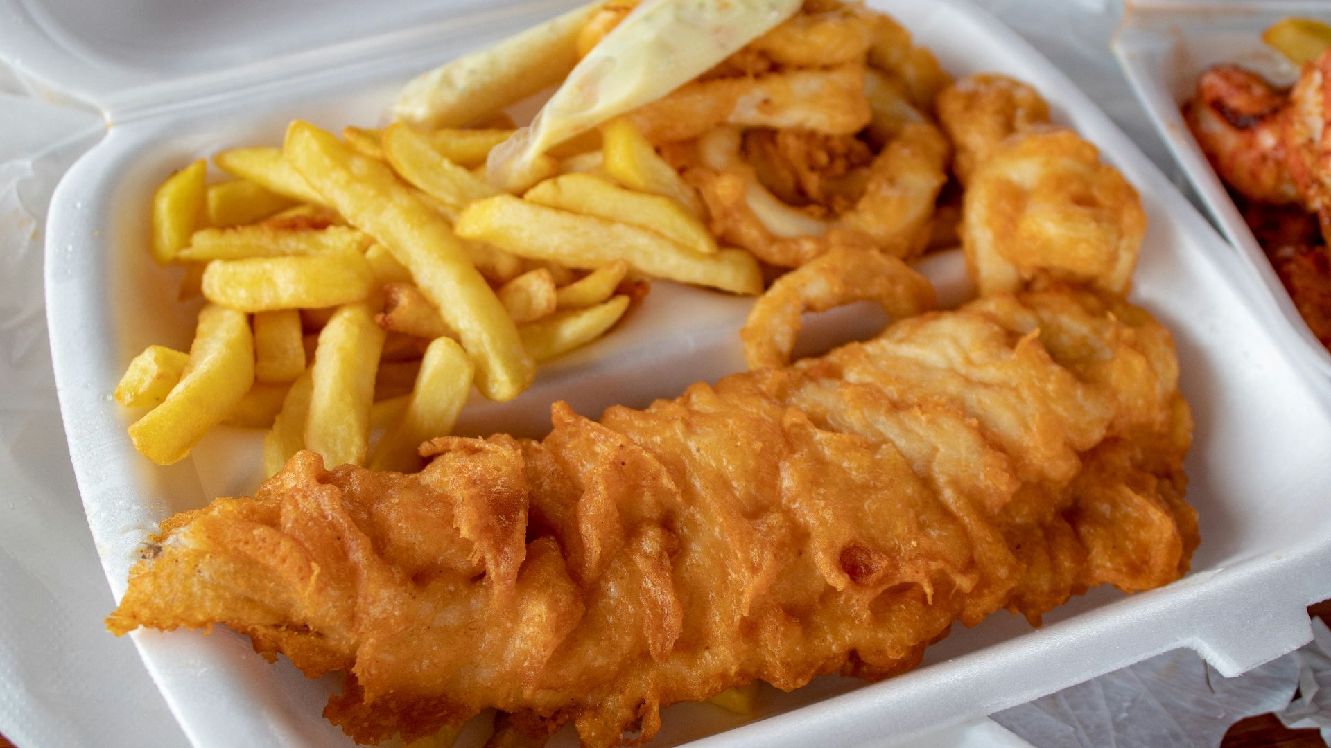 cooked meat and French fries in white disposable plate