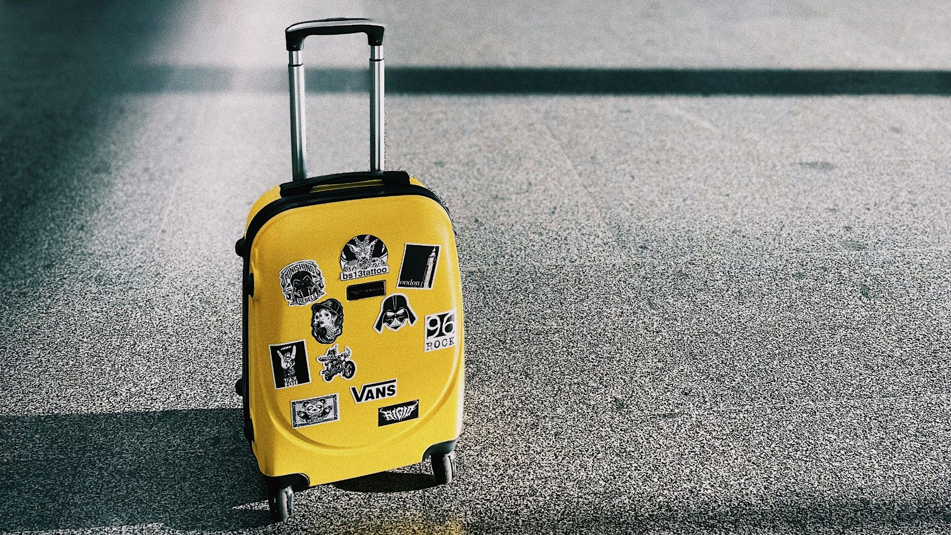 a yellow piece of luggage sitting on top of a floor