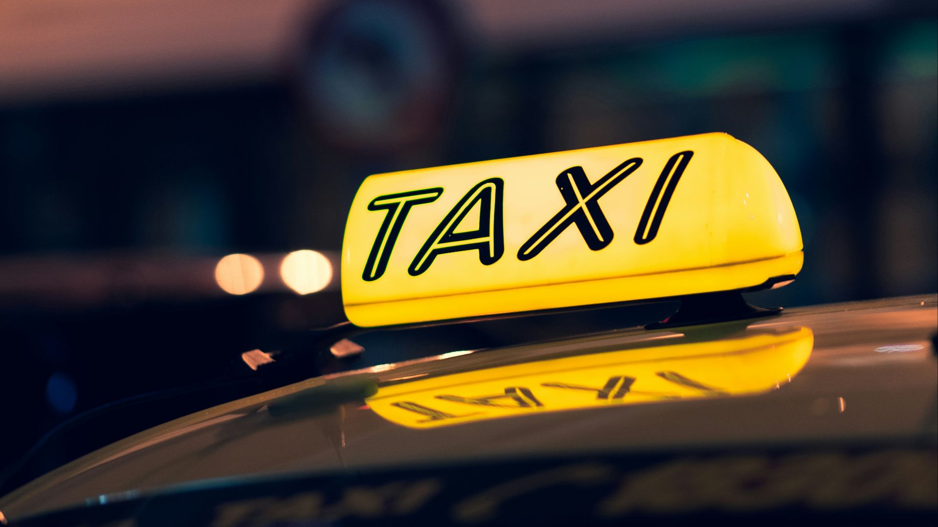 yellow taxi cab on road during night time