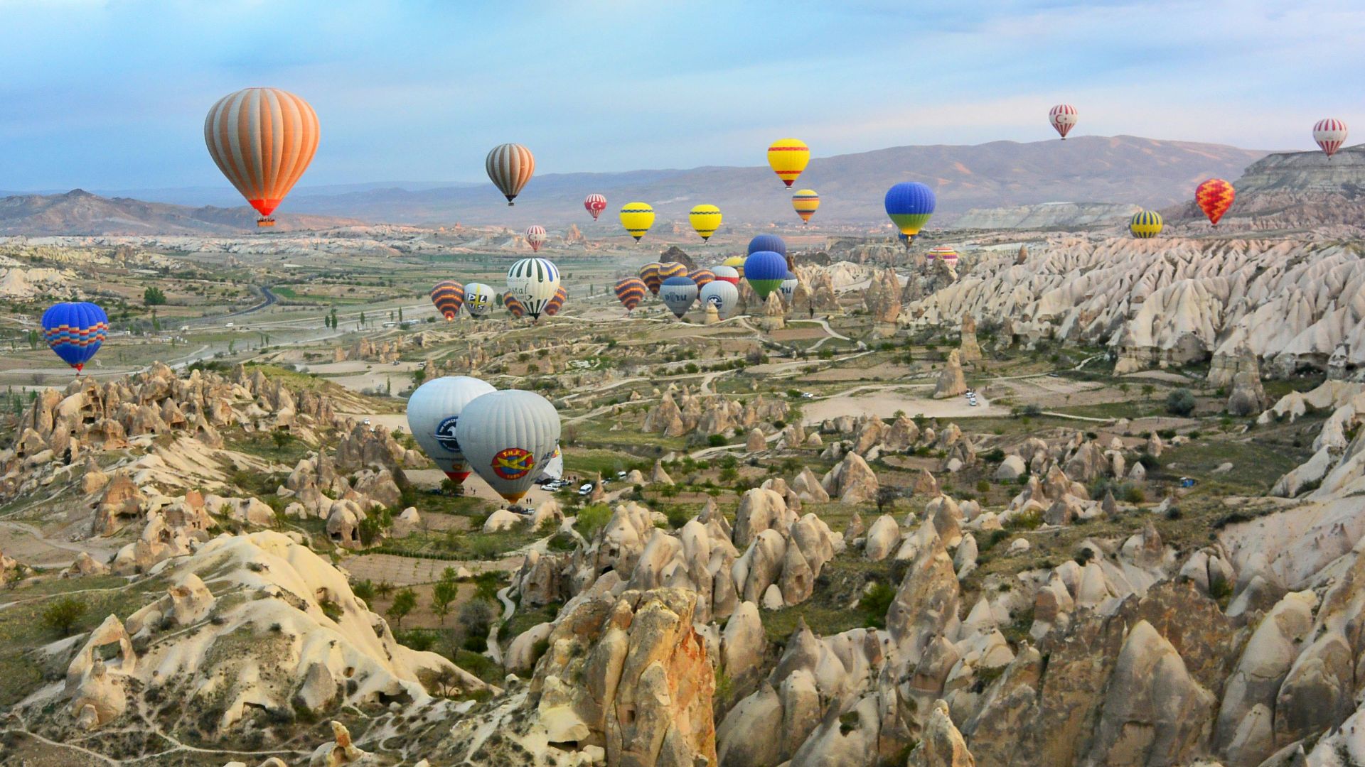 photo of assorted-color air balloon lot in mid air during daytime