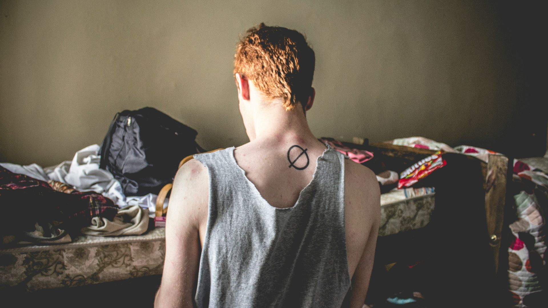 man in front of bed praying