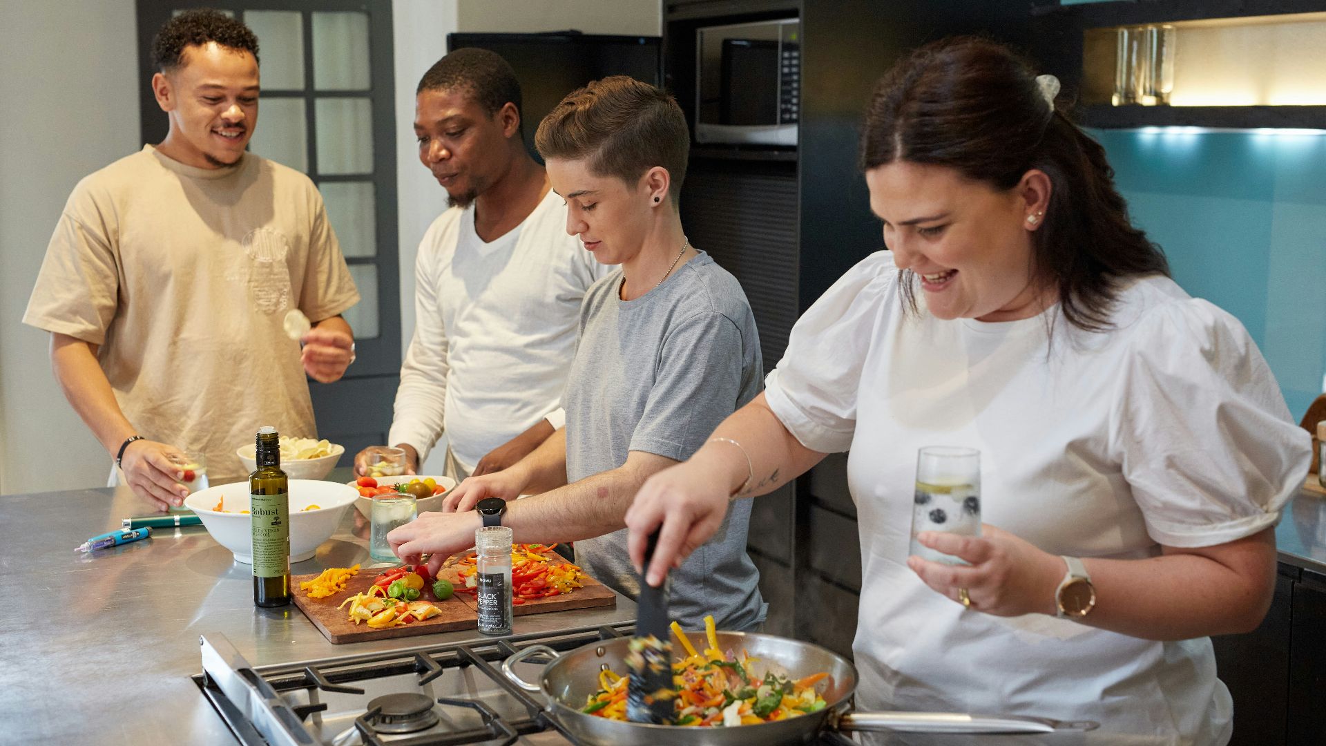 a group of people preparing food in a kitchen
