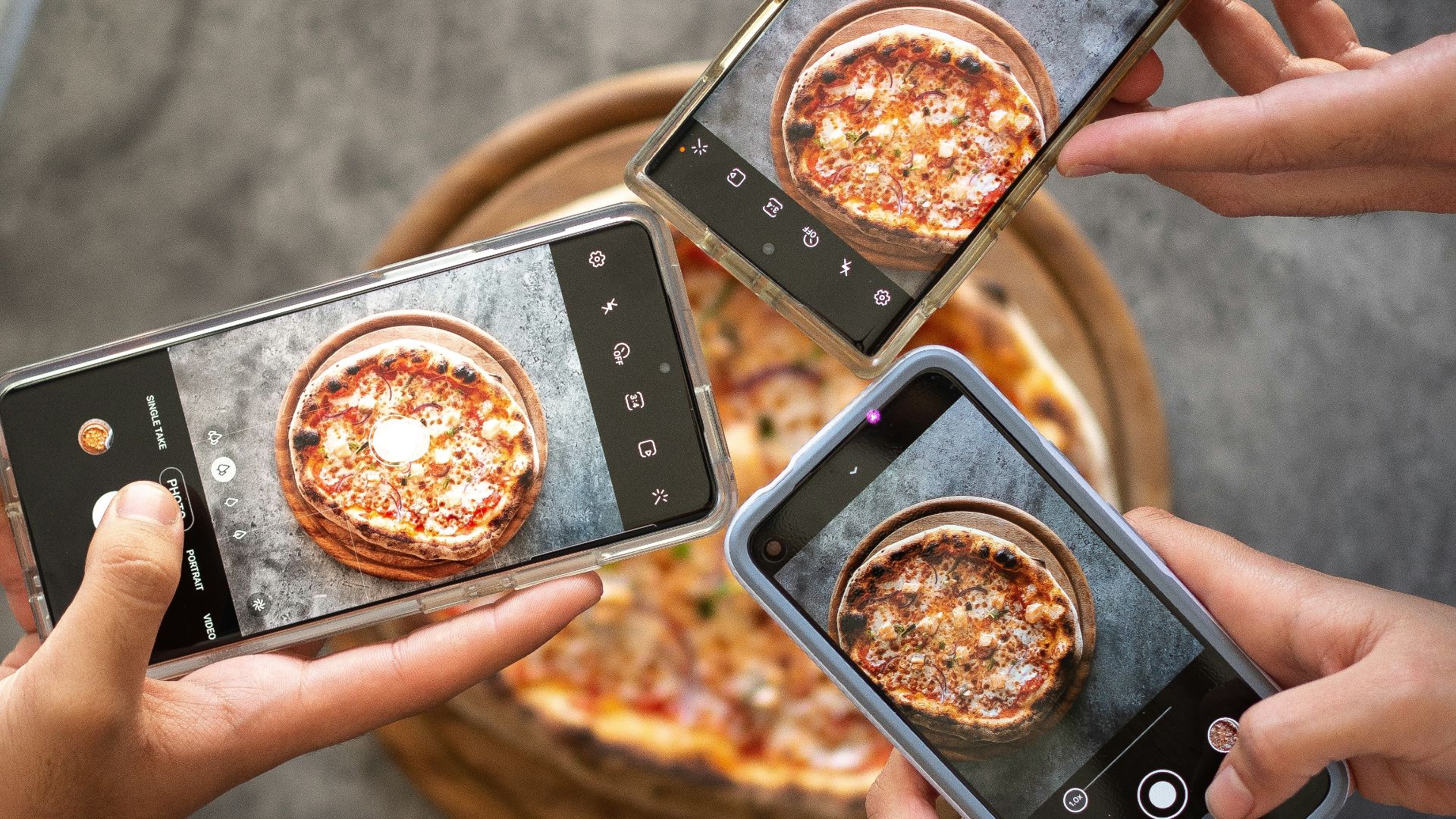 person holding black smartphone taking photo of pizza