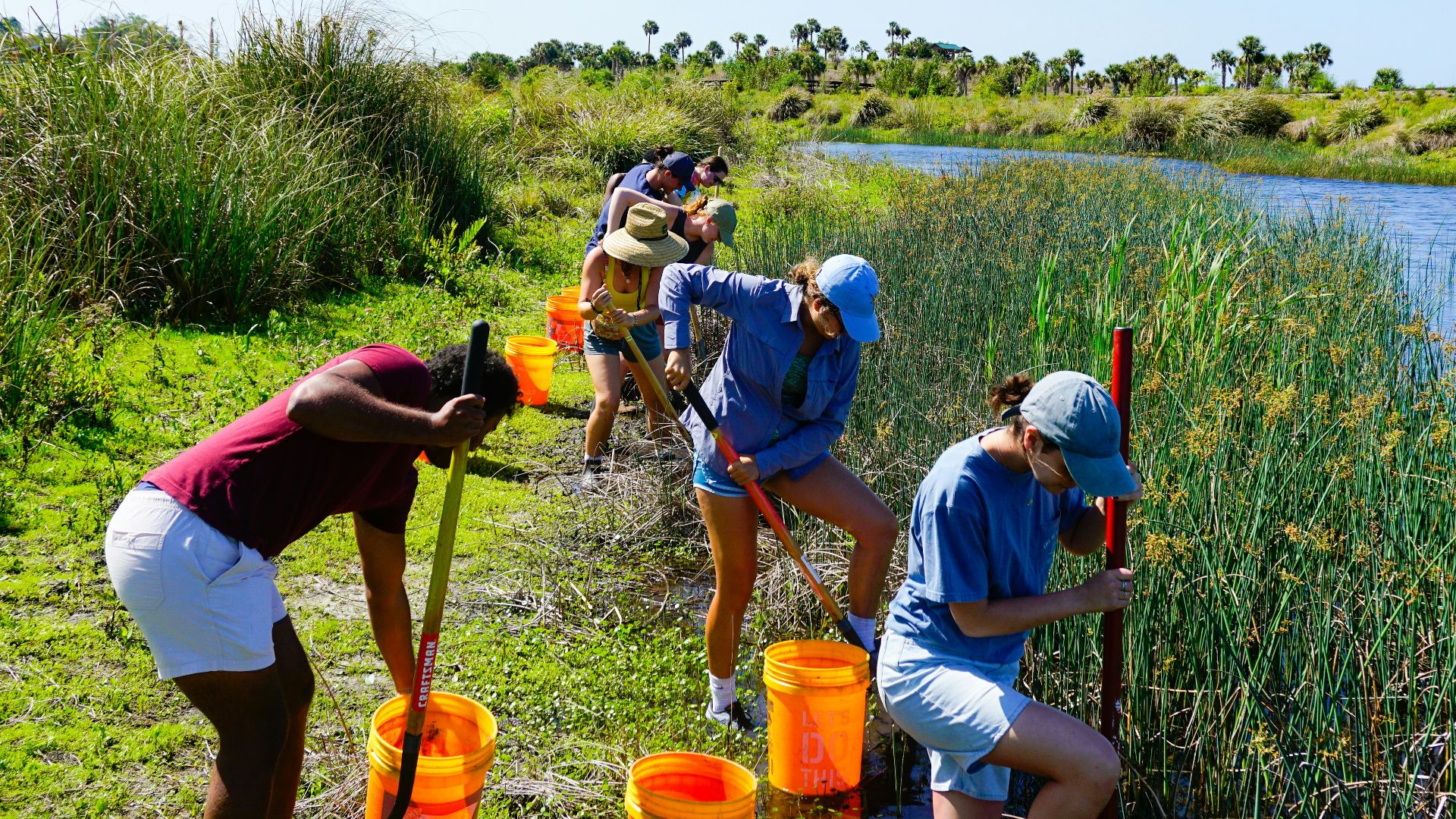 a group of people standing next to a river