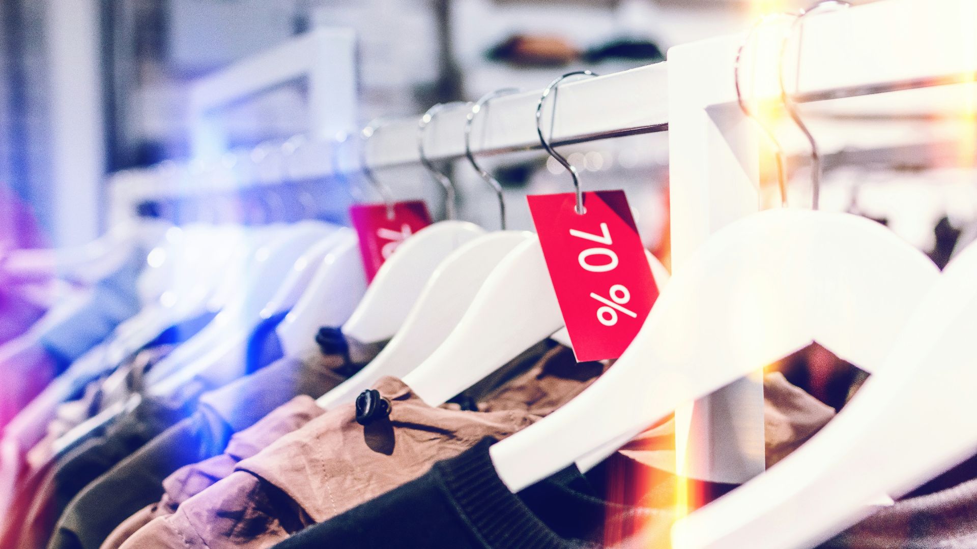 person holding white plastic clothes hanger