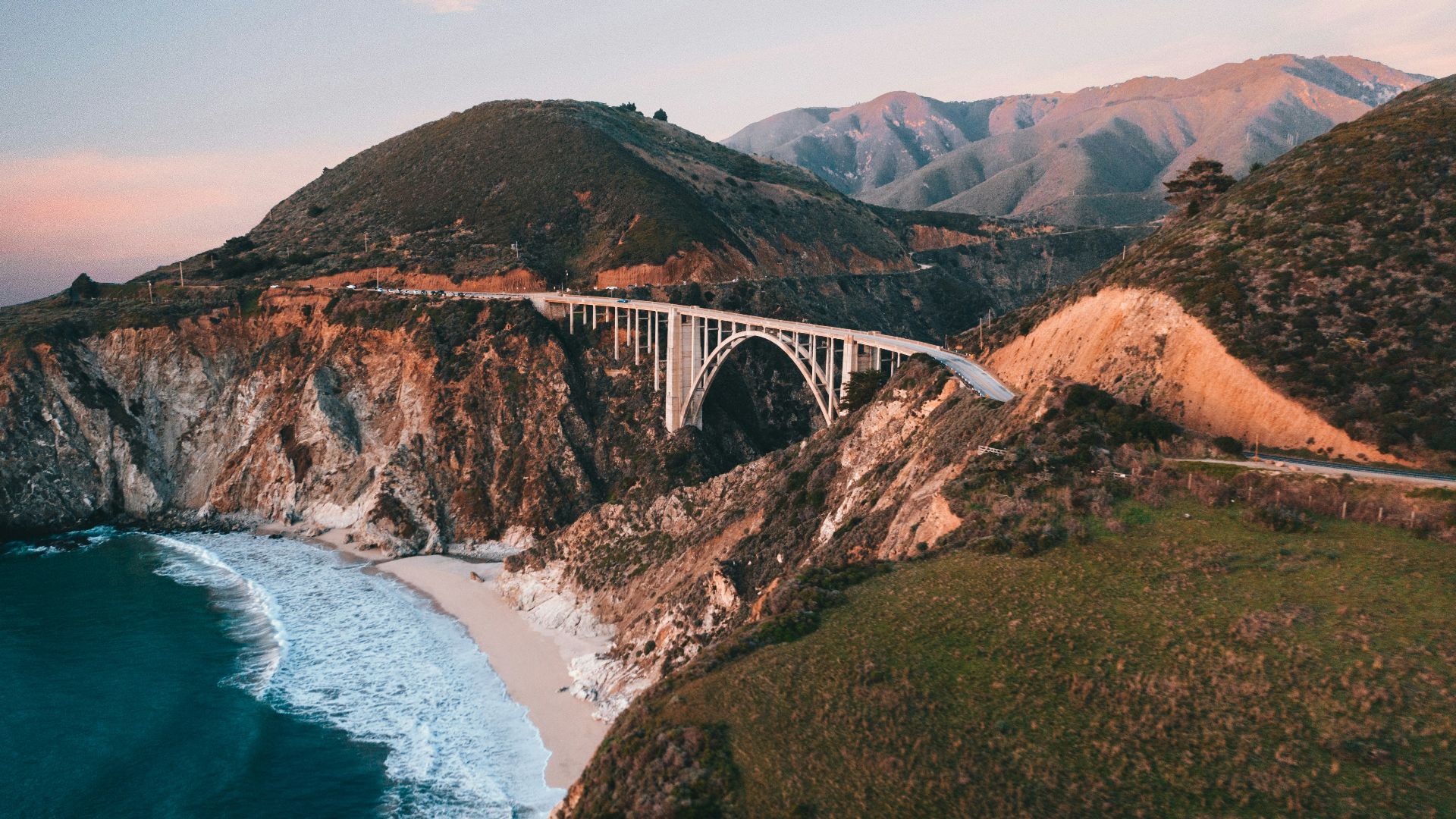 white bridge over the sea during daytime