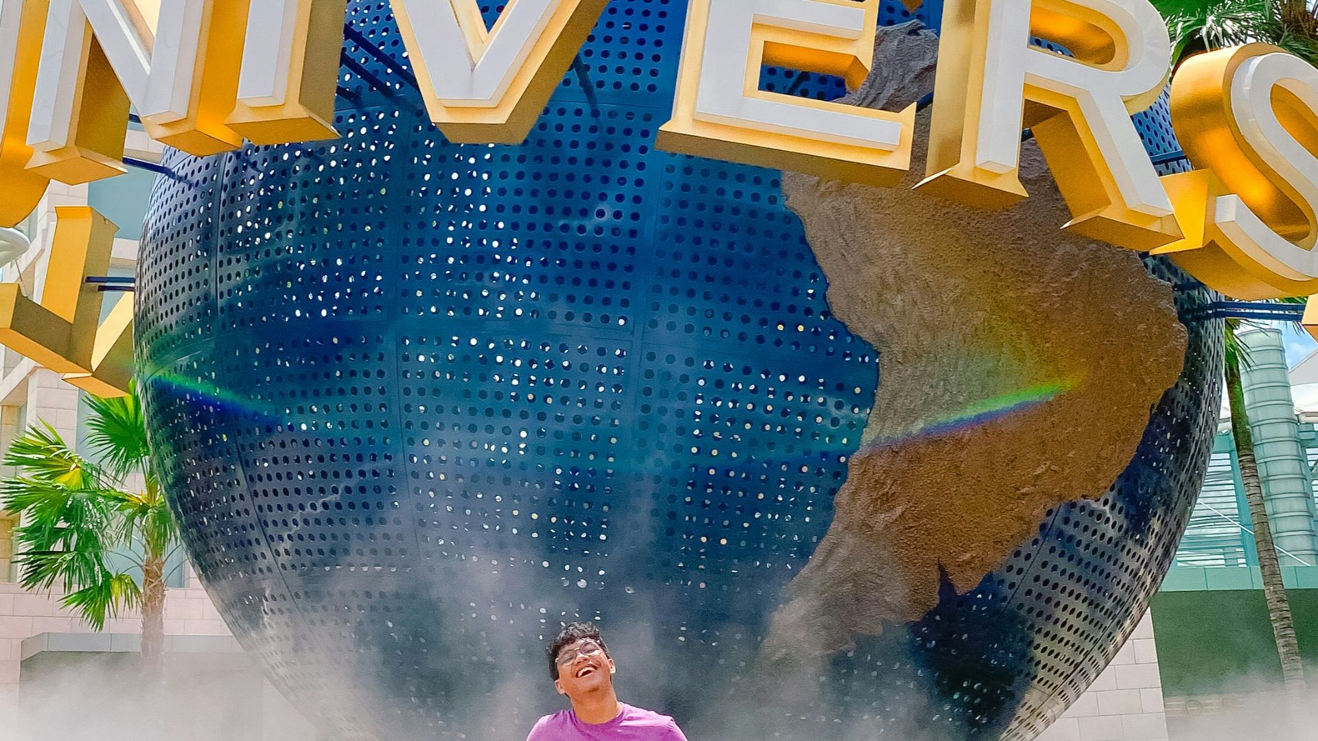 a man standing in front of a giant sign