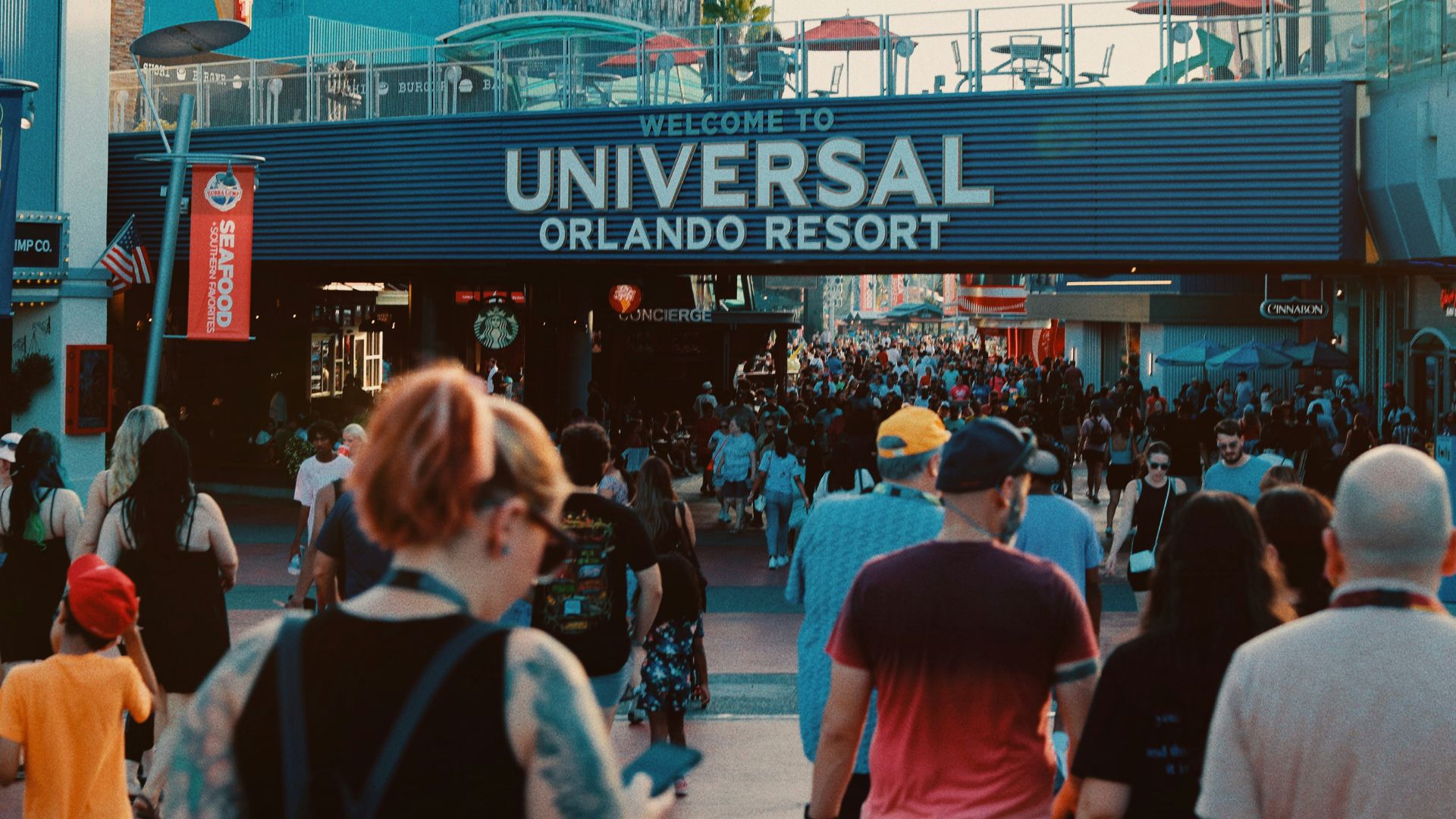 a crowd of people walking down a street next to a building