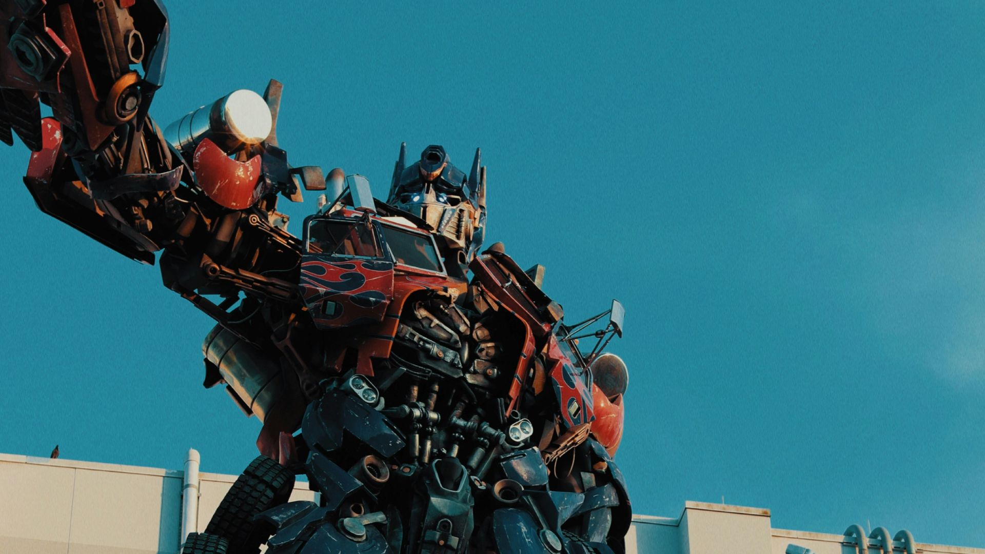 a giant statue of a transformer standing on top of a building