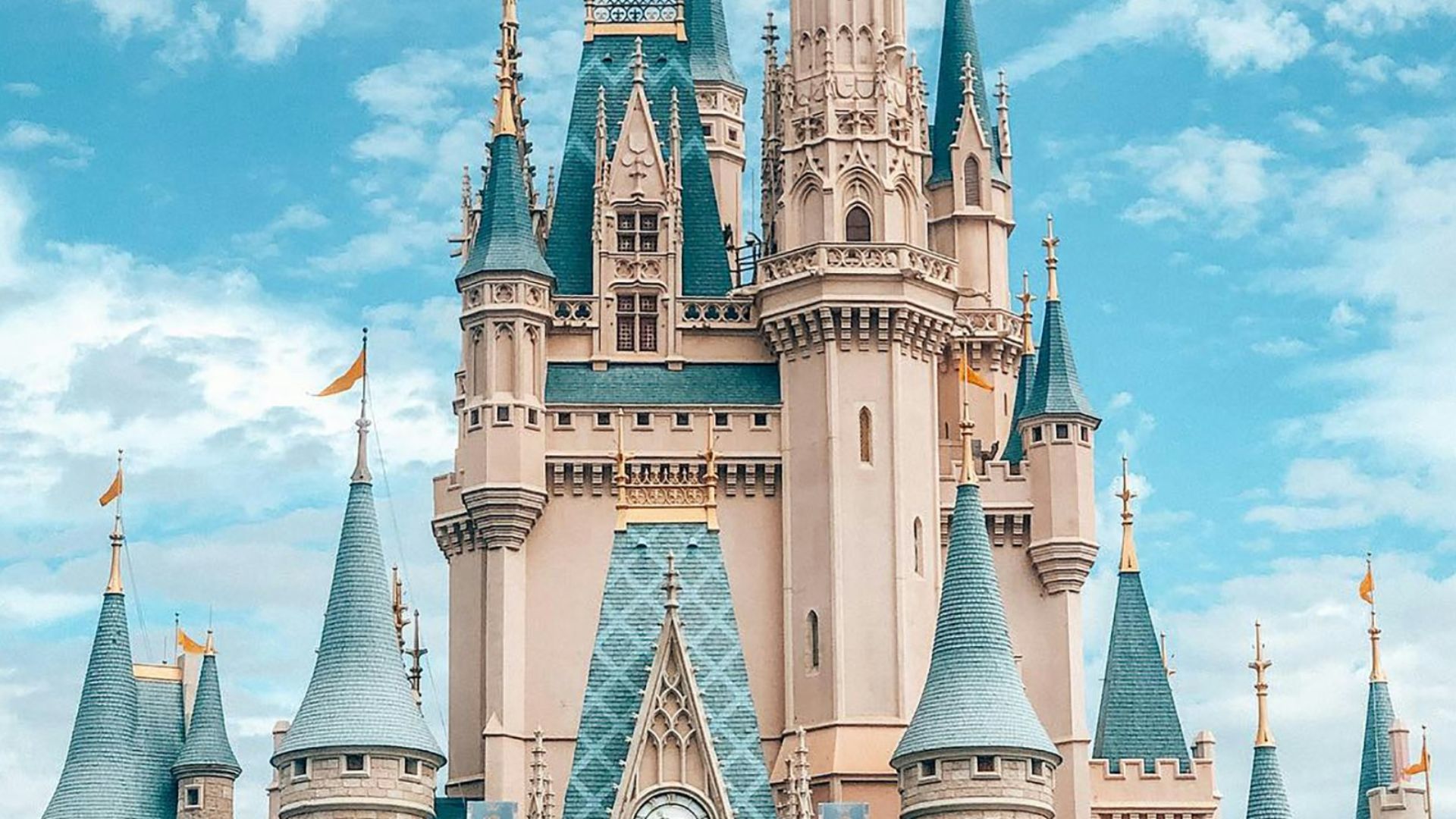 white and blue castle under blue sky and white clouds during daytime