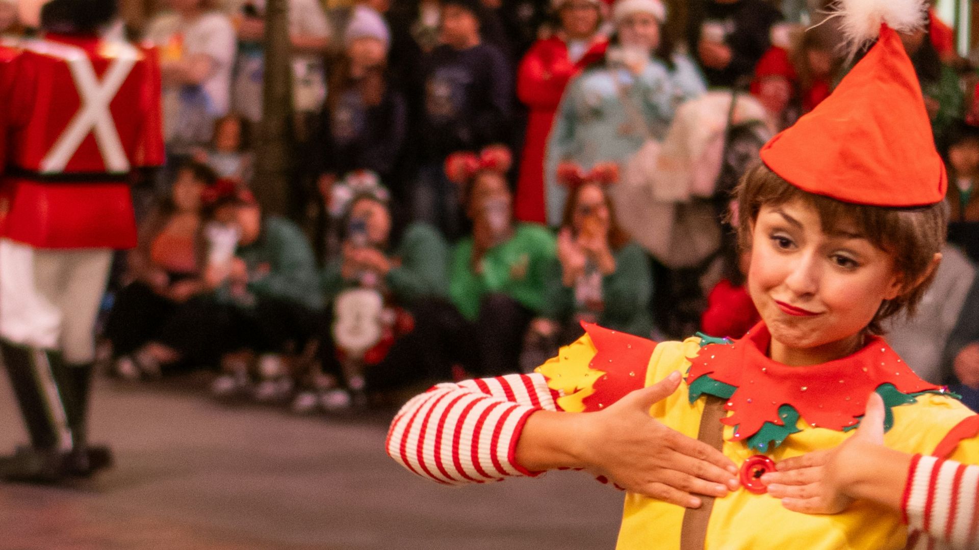 a small child dressed as a clown in a parade