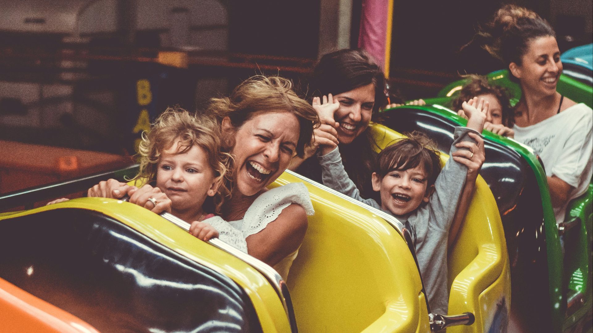 people riding on roller coaster during daytime