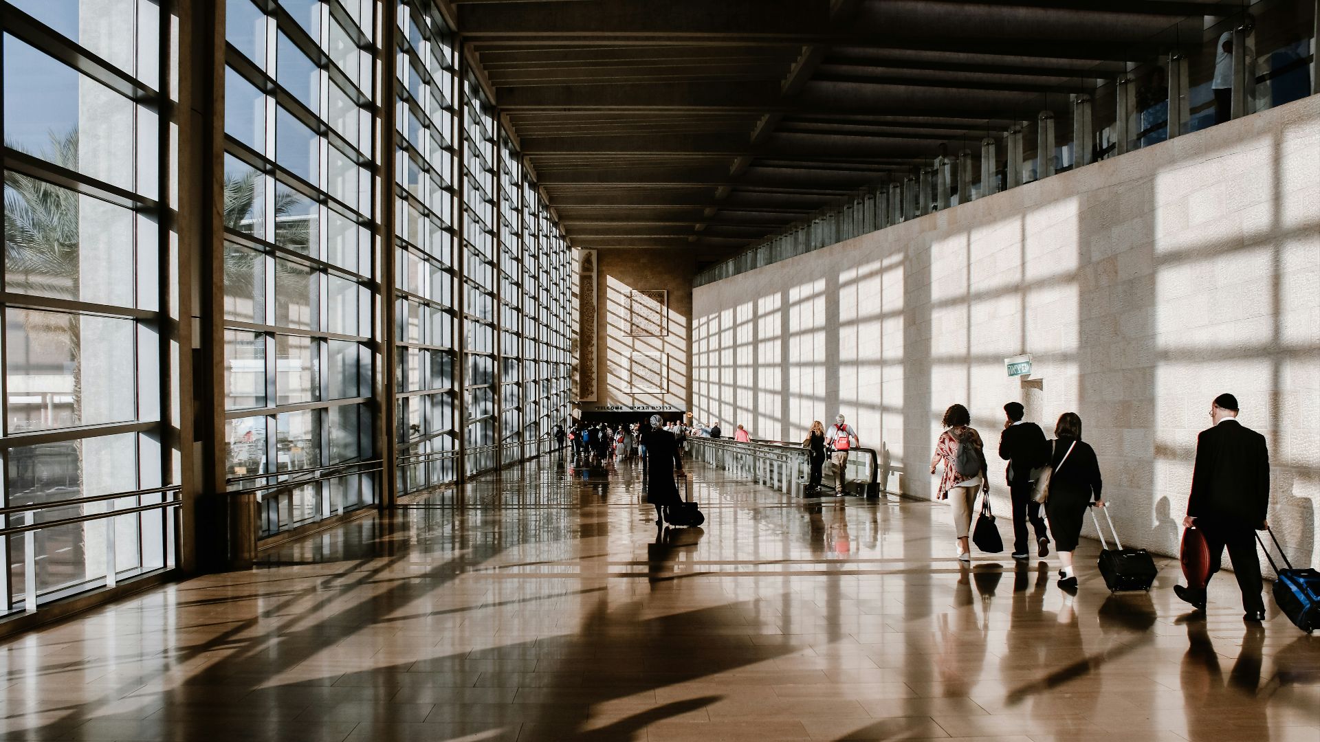 group of people walking beside white building