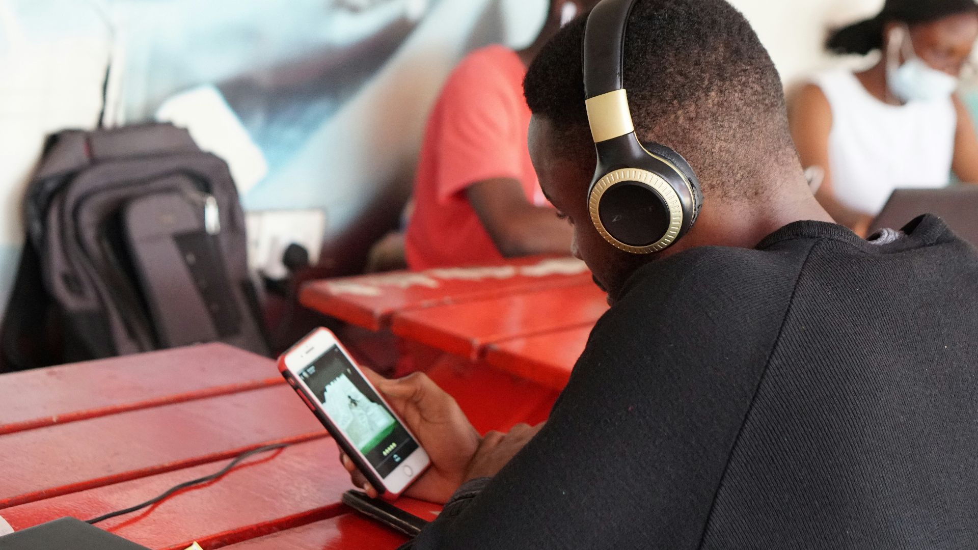 man in black long sleeve shirt holding red and black camera