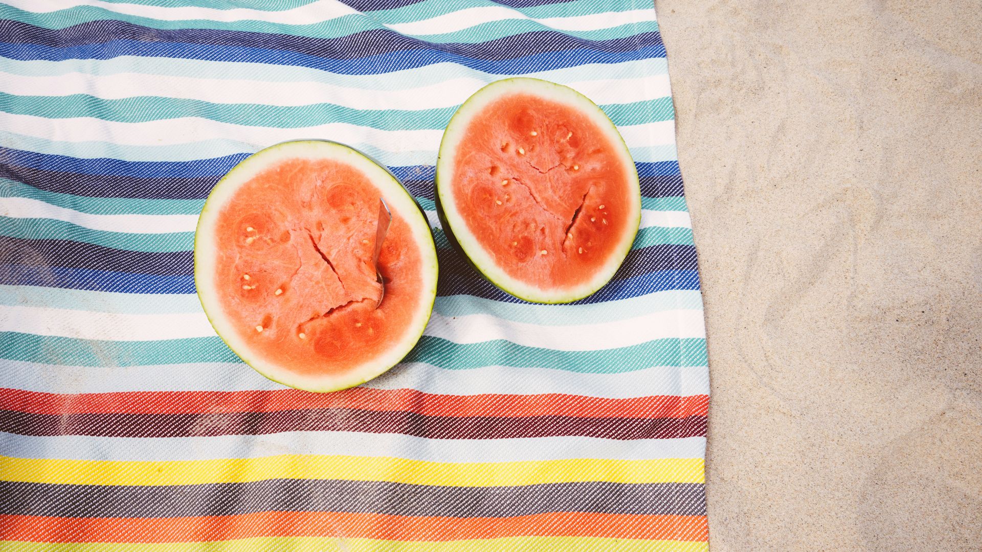 closeup photo of slice watermelon fruits on cloth