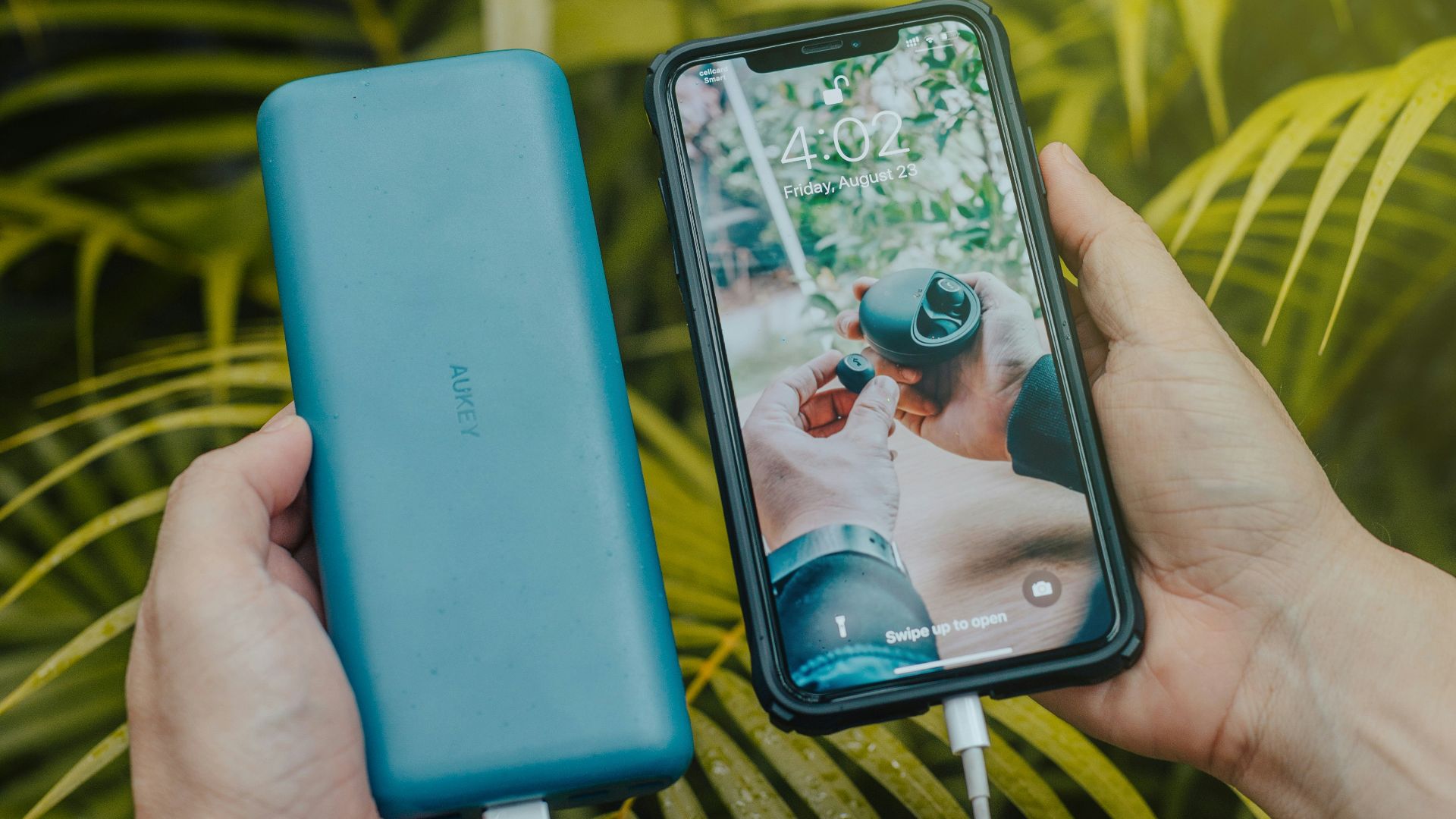 black smartphone and green powerbank close-up photography