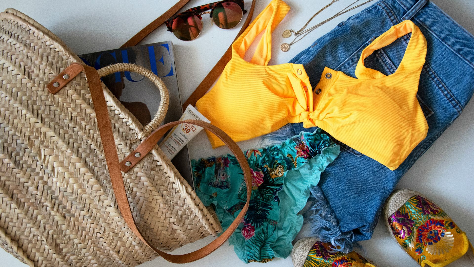 blue denim jeans beside yellow leather handbag