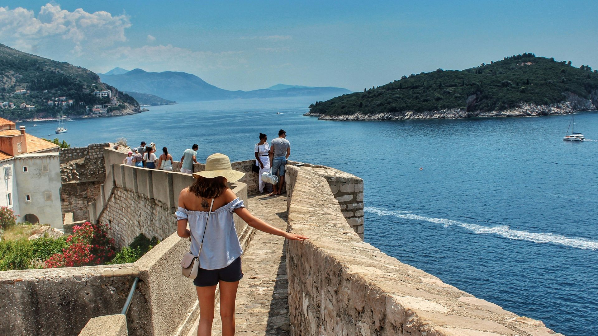 people walking on concrete pathway