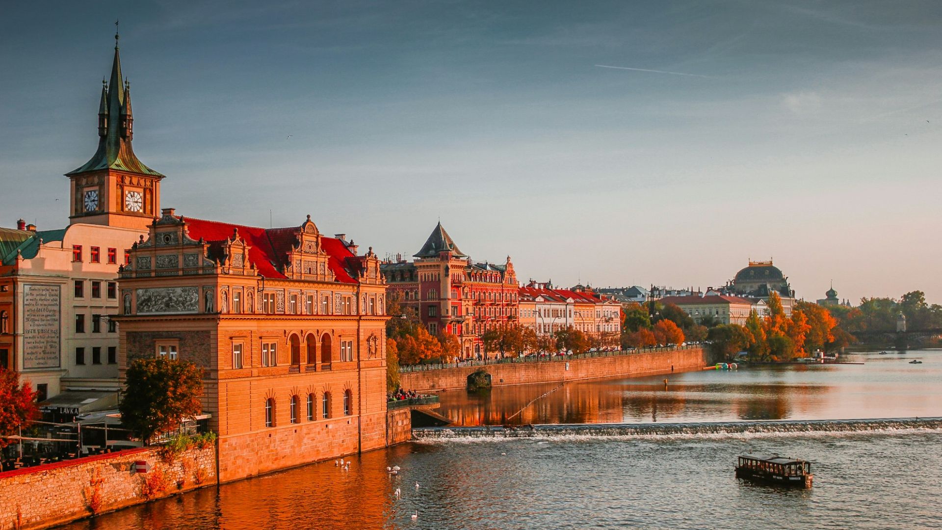 photo of boat on body of water near high-rise buildings