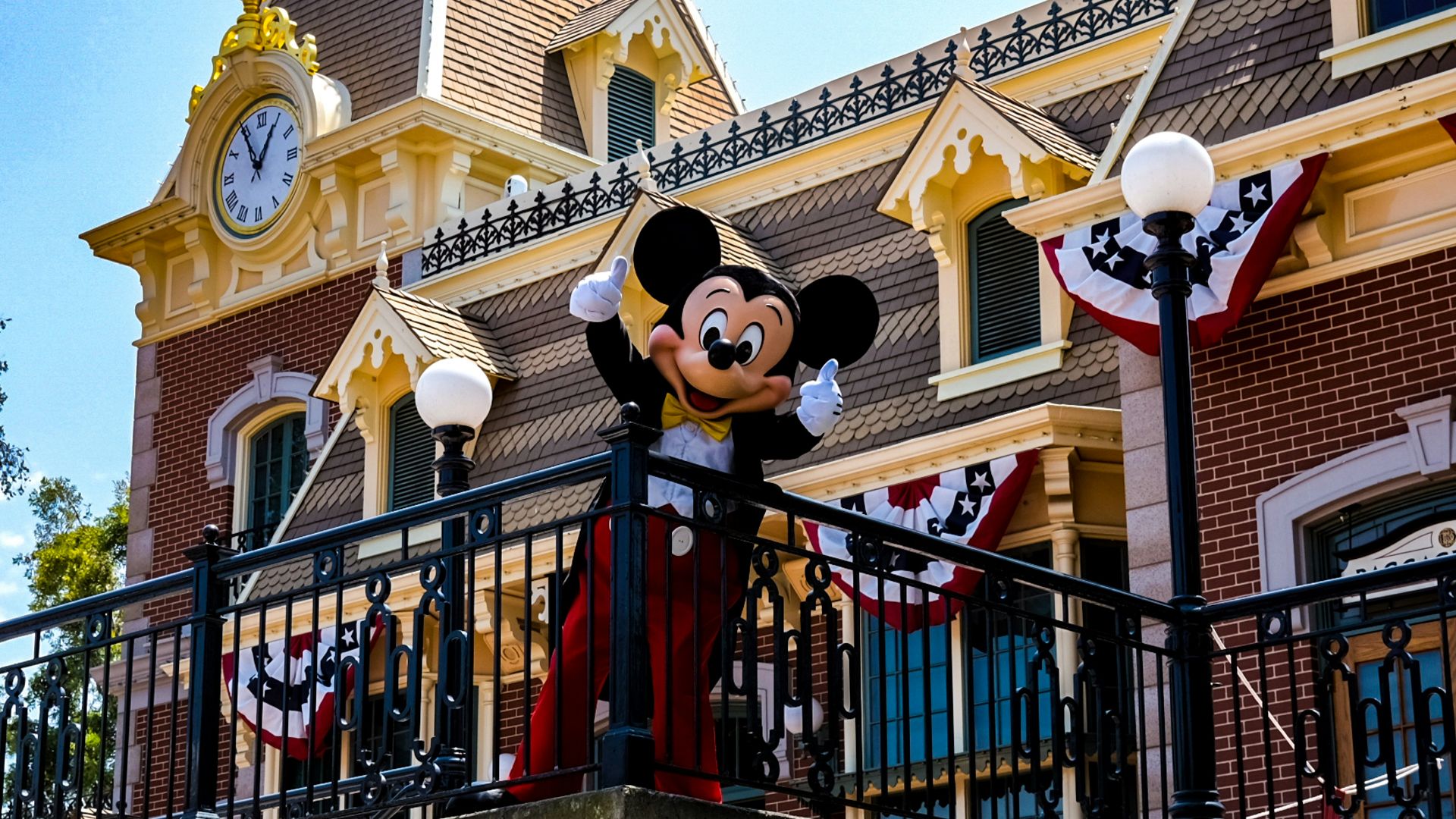 a mickey mouse statue on top of a building