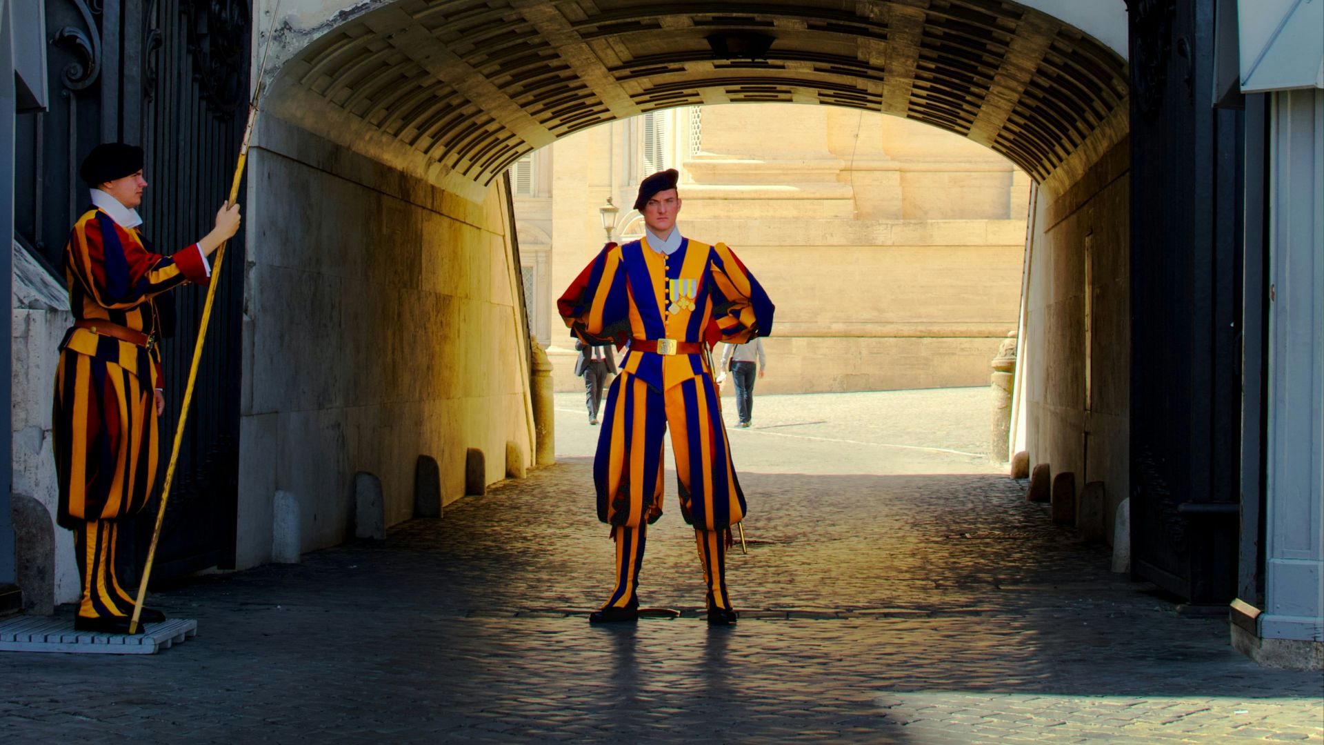 man in red and black suit standing on gray concrete floor
