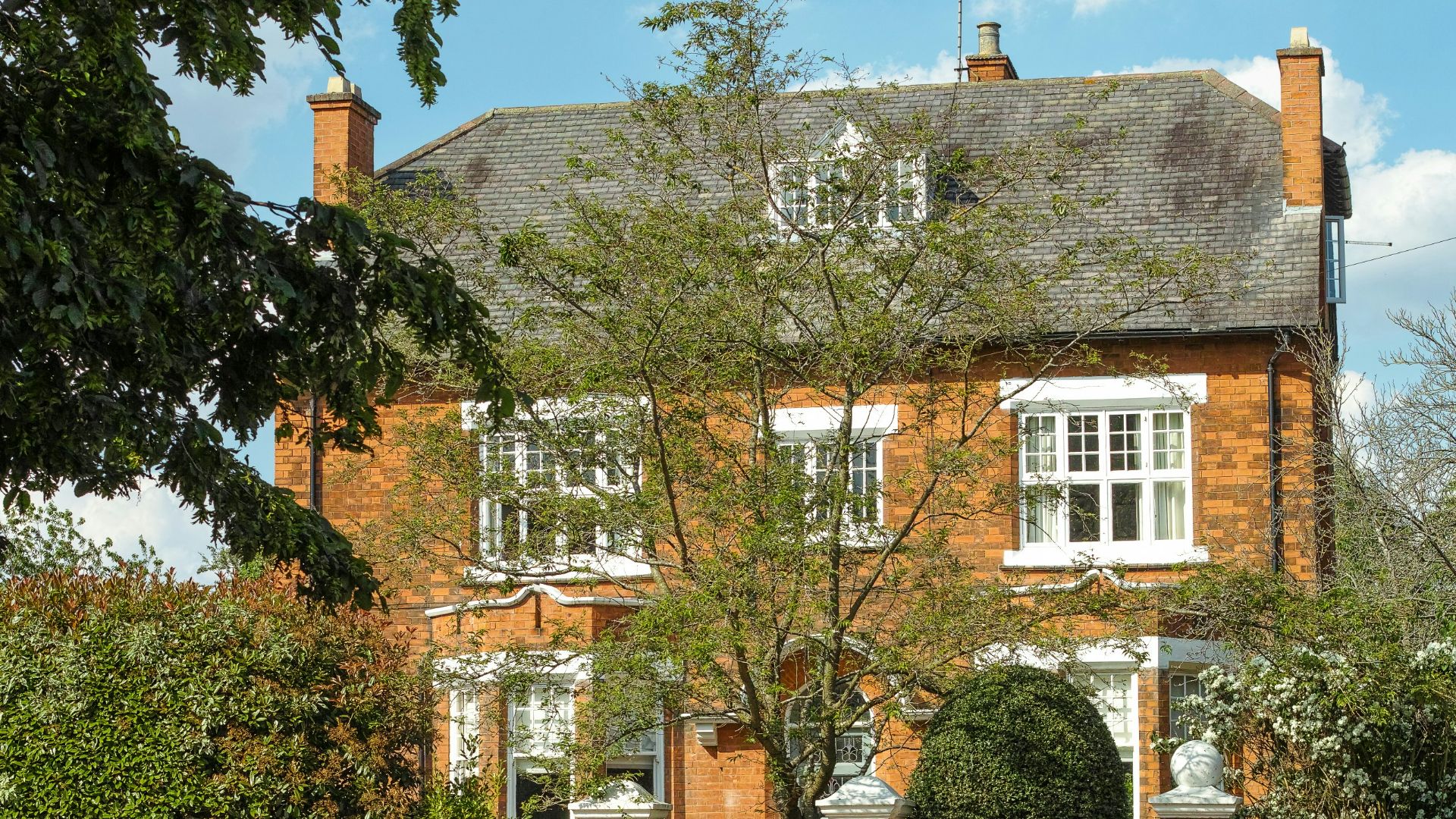 a large brick building with a tree in front of it