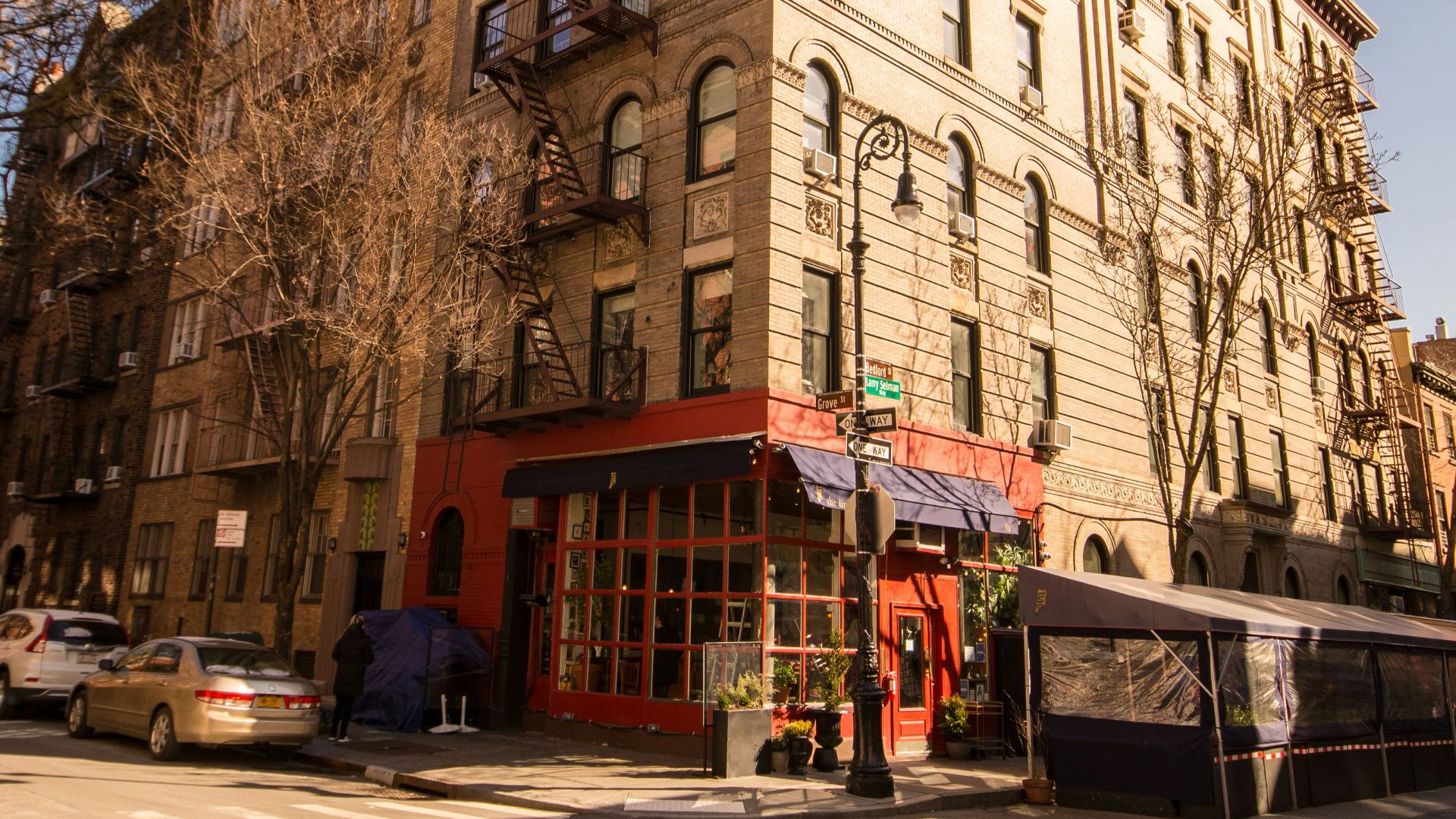 a large brown building with many windows next to a street