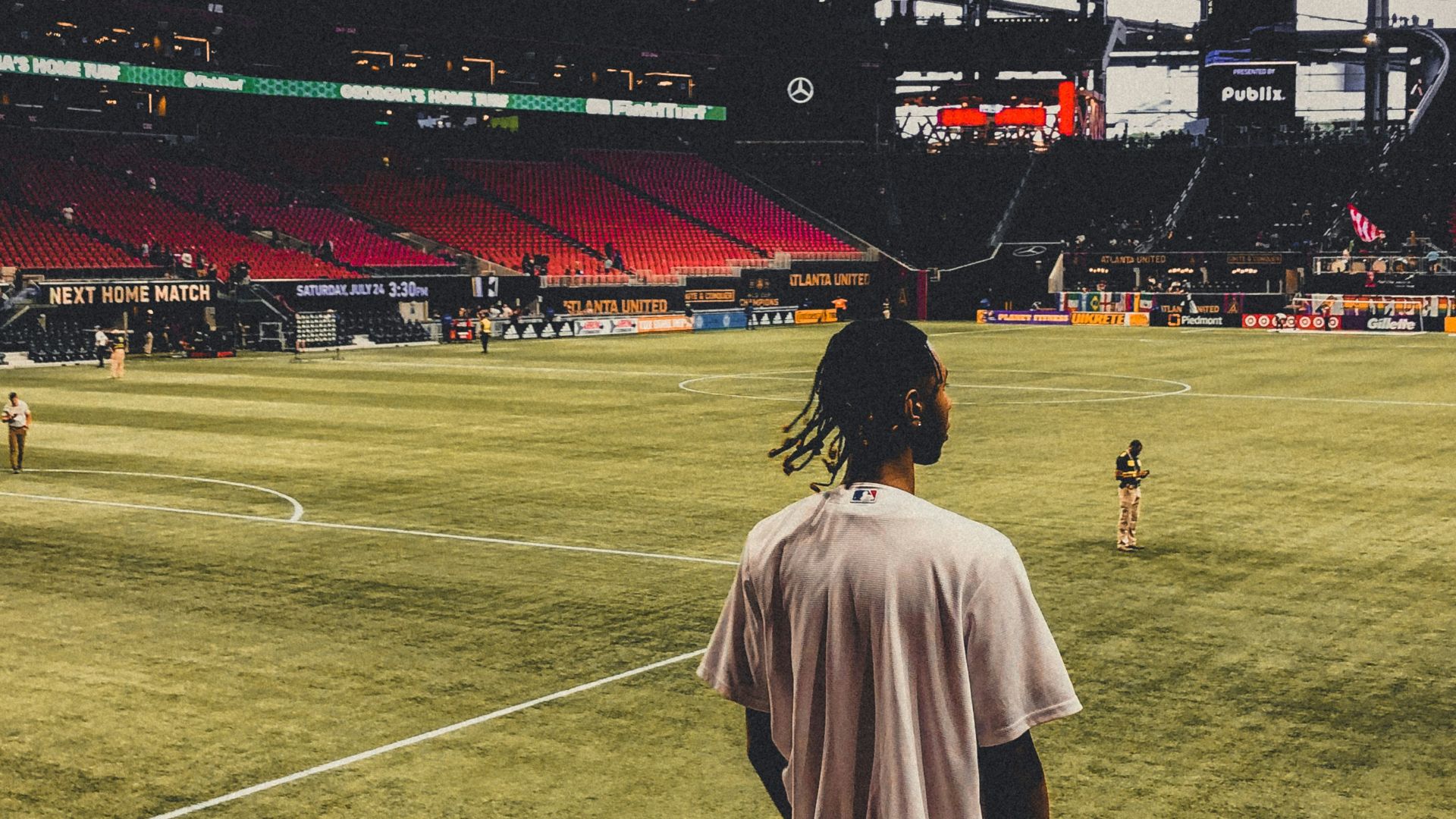 a person standing in a stadium watching a baseball game