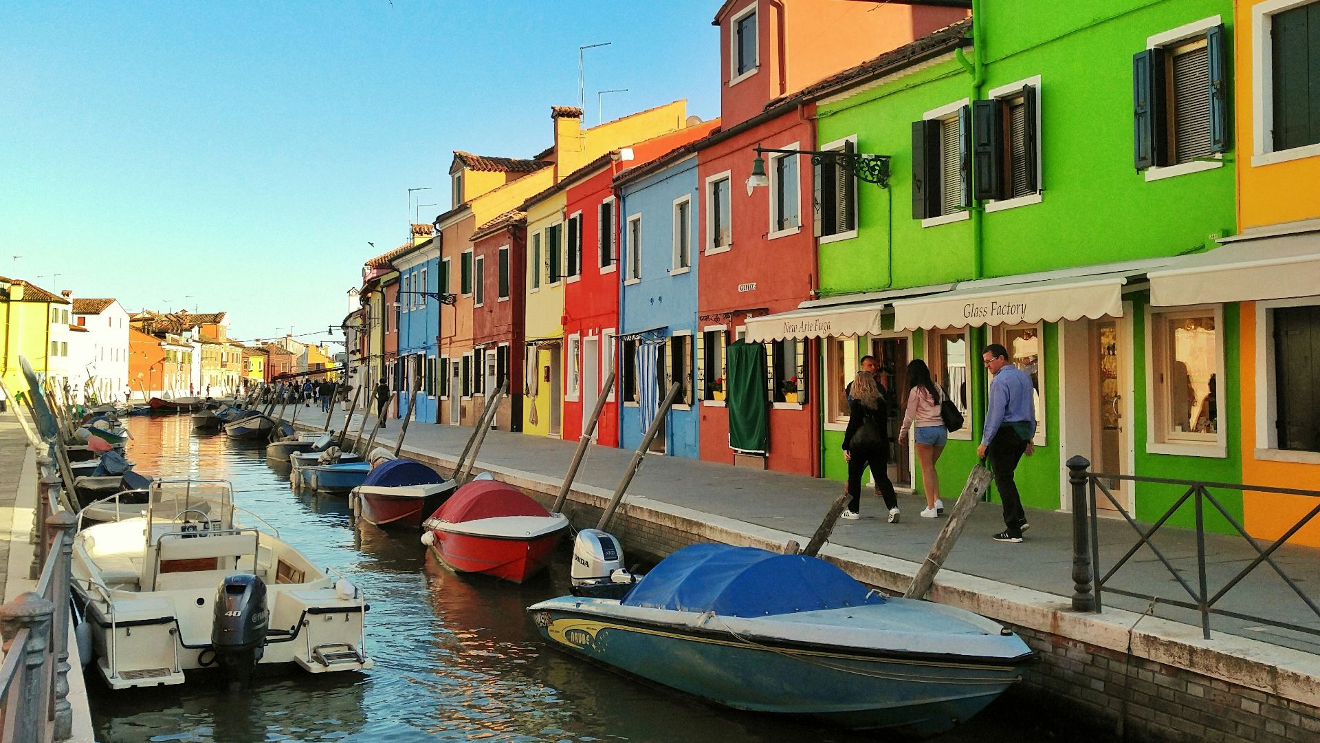 motorboats parked beside multicolored houses