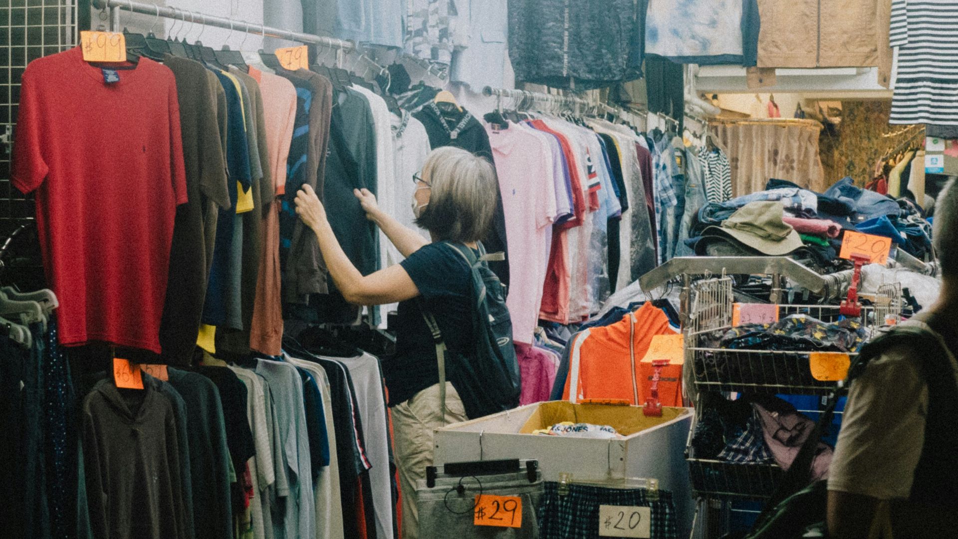 a person looking at a rack of clothes
