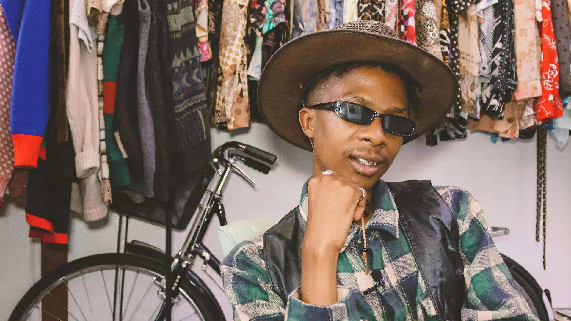 woman in green white and black plaid button up shirt wearing black hat